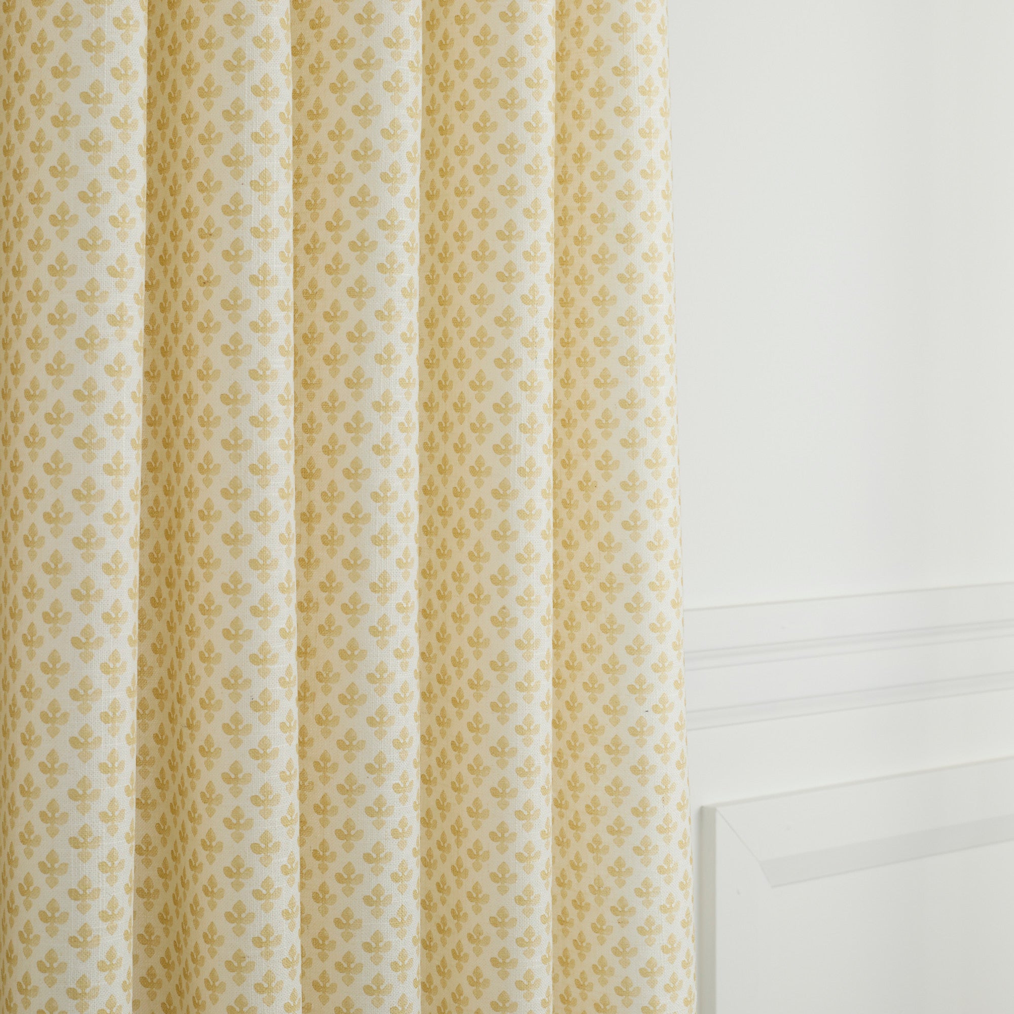 Lyra Butter Yellow curtain fabric by Tonic Living — soft linen-blend fabric with a delicate white and yellow floral block print.