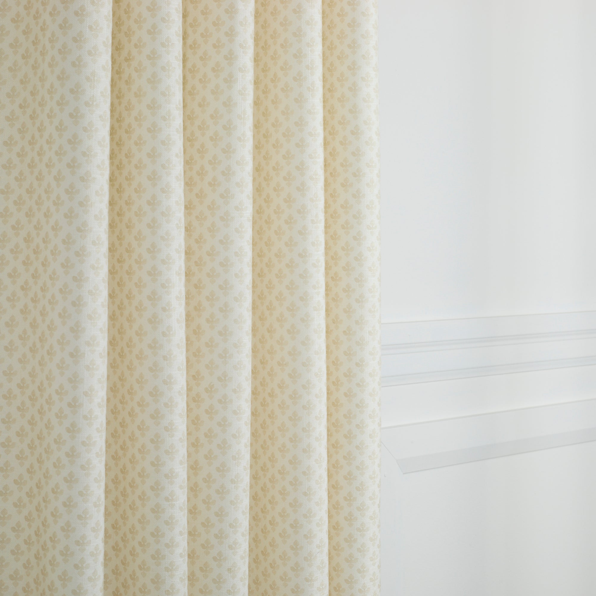 Lyra Parchment curtain fabric by Tonic Living — soft neutral linen-blend fabric with a warm white and beige floral block print.