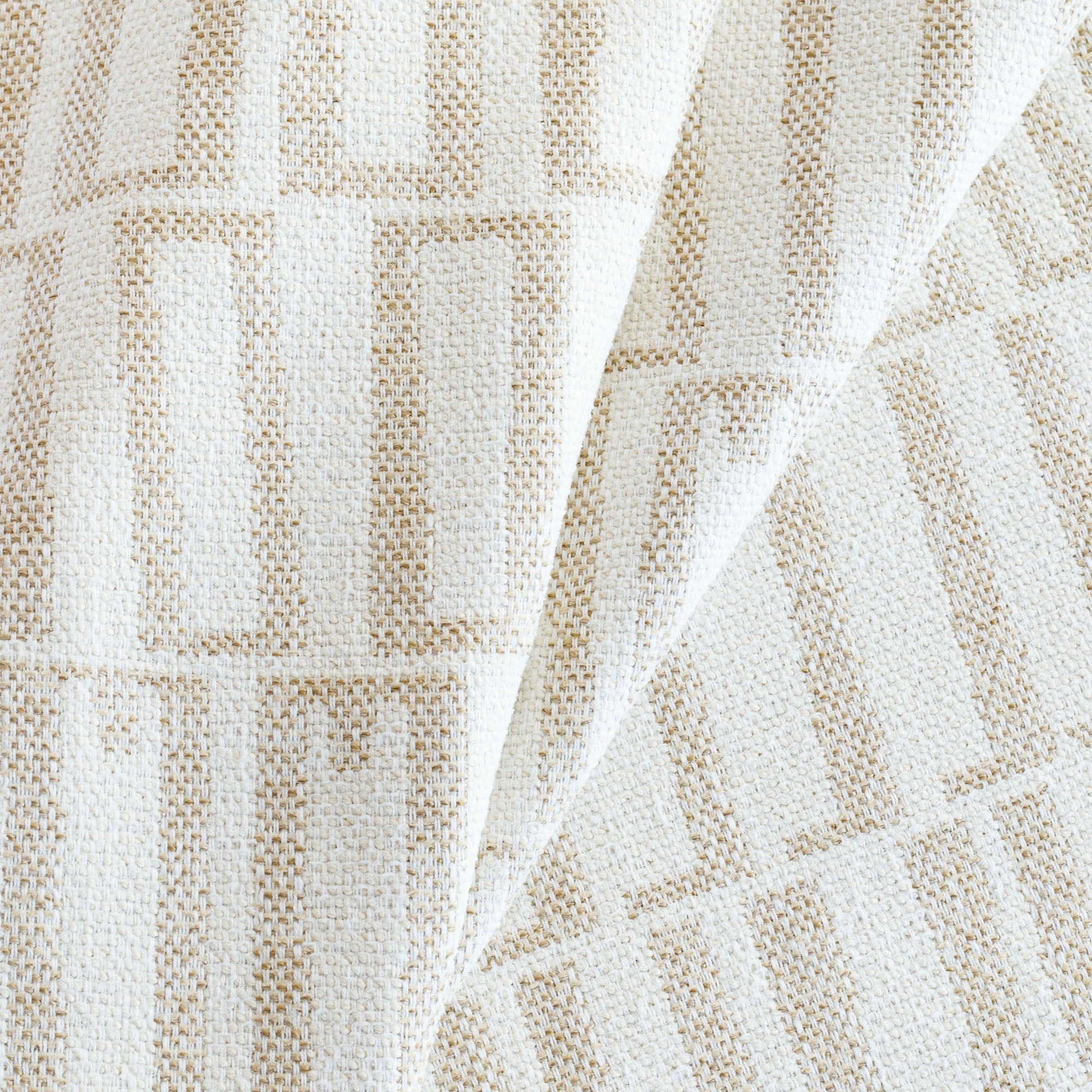 a beige and white abstract geometric patterned outdoor upholstery fabric : close up view