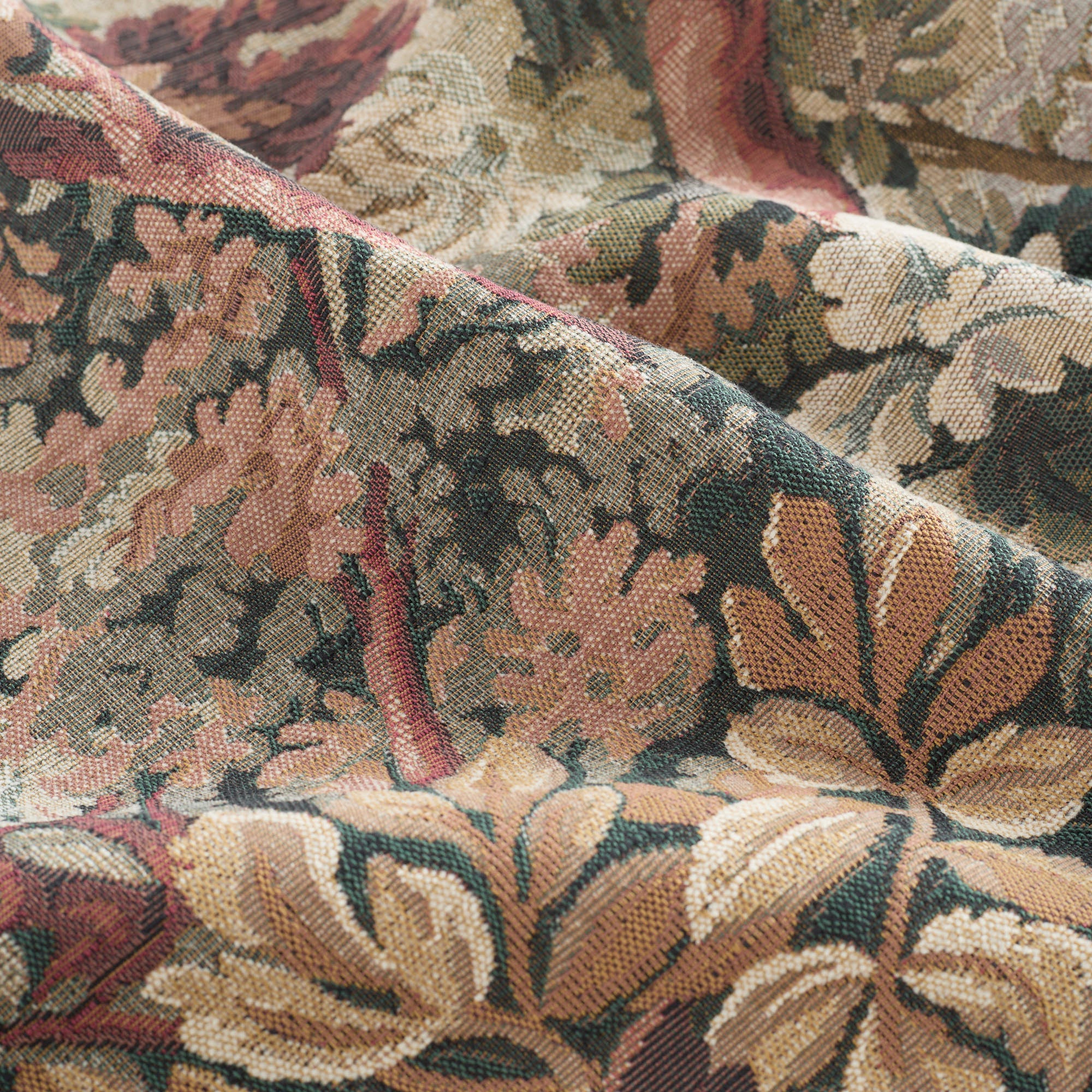 Close-up of Manor Tapestry Fabric, Burgundy by Tonic Living – large-scale woven tapestry pattern.