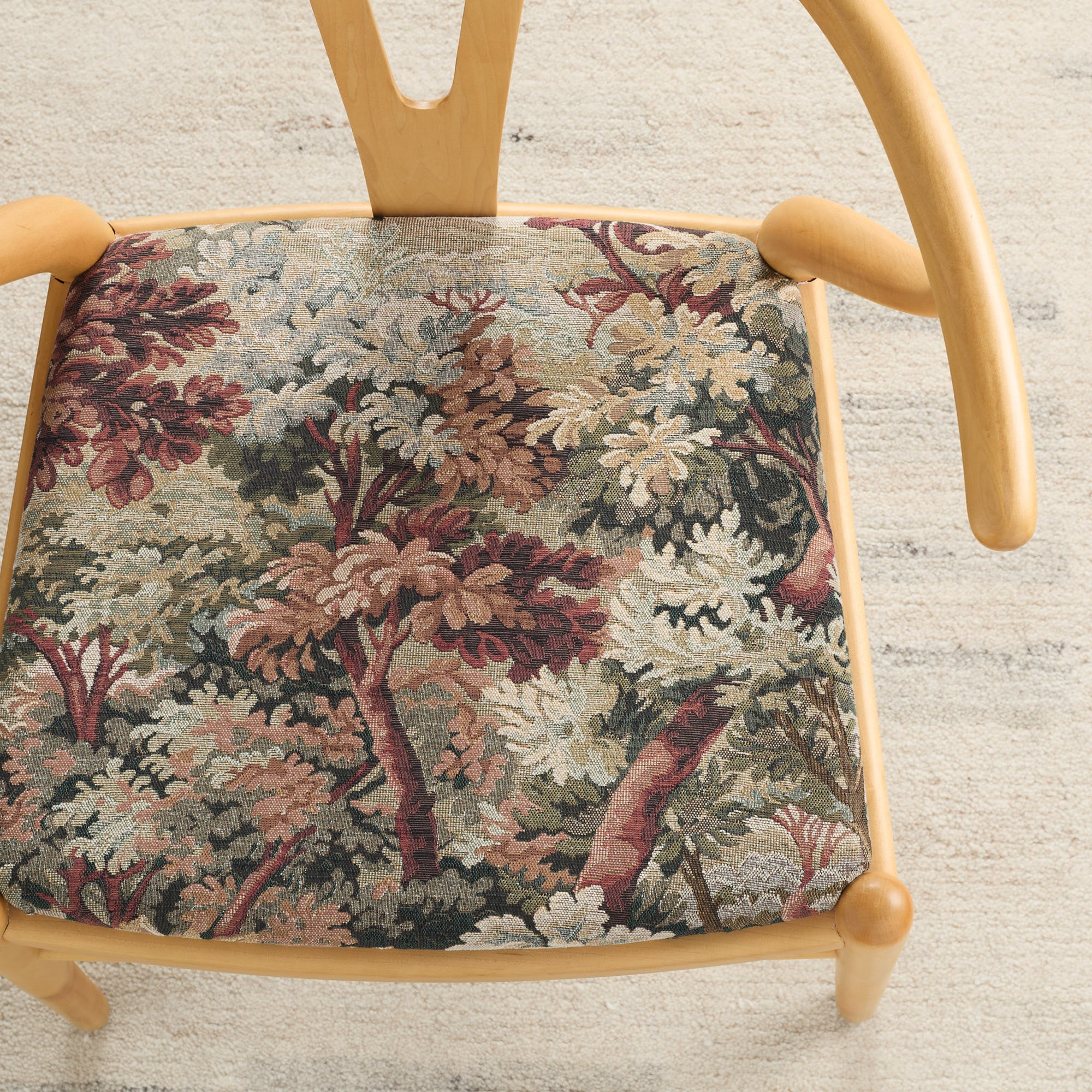 Burgundy tapestry fabric by Tonic Living shown upholstered on a dining chair seat – rich home decor textile.