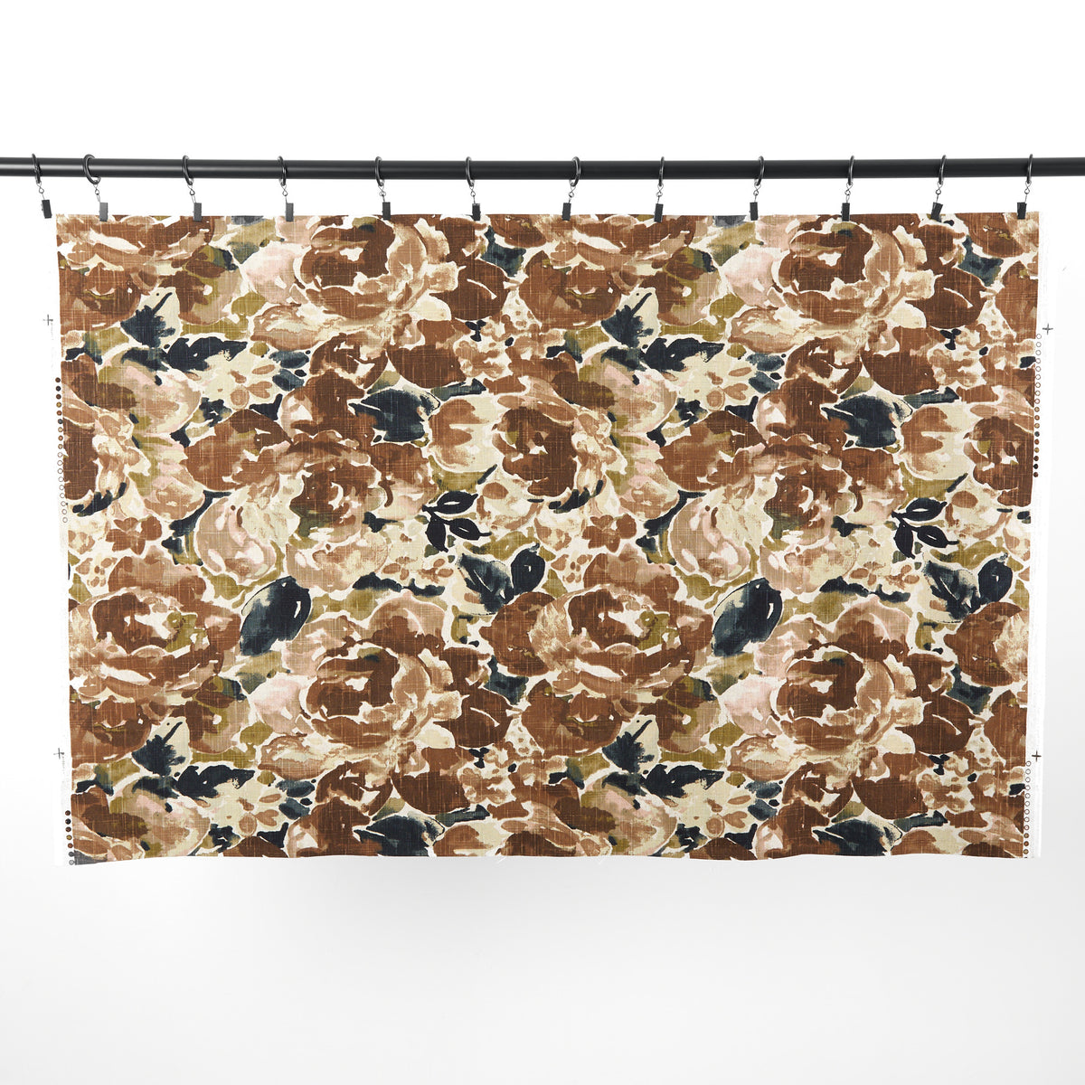 Full yard of Tonic Living Marbella Fabric in Inkwell hanging to show the scale and drape of its brown and blue abstract floral pattern.