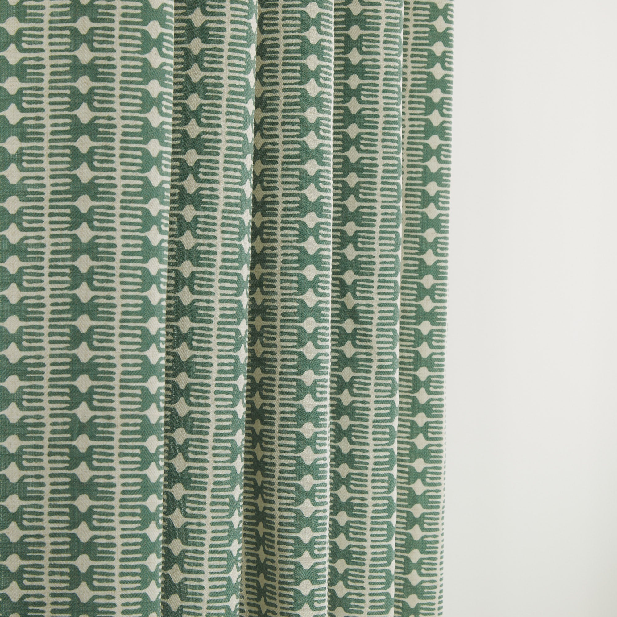 Tonic Living Meadow Emerald drapery fabric in a global-inspired green and soft white print.