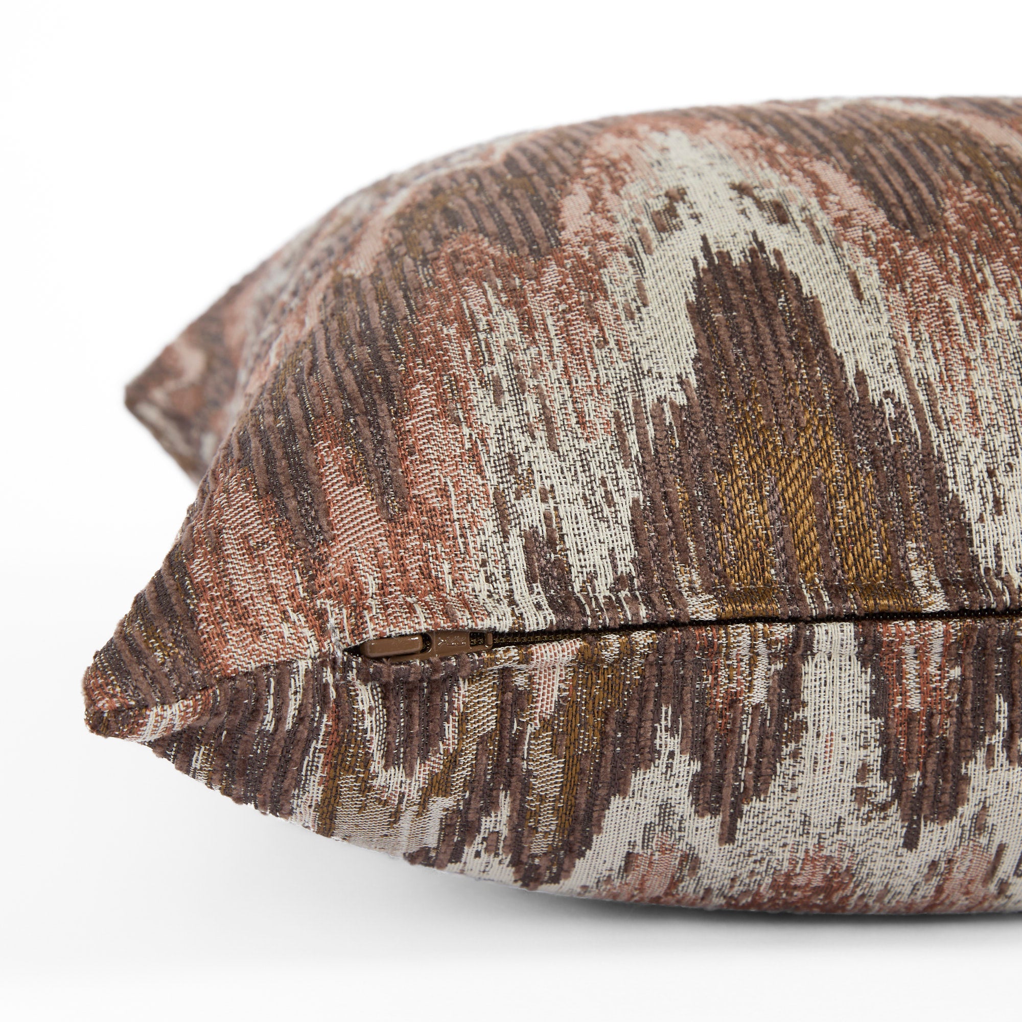 Side zipper detail of Tonic Living Mendoza 20x20 pillow in earthy plum and terracotta pink tones.