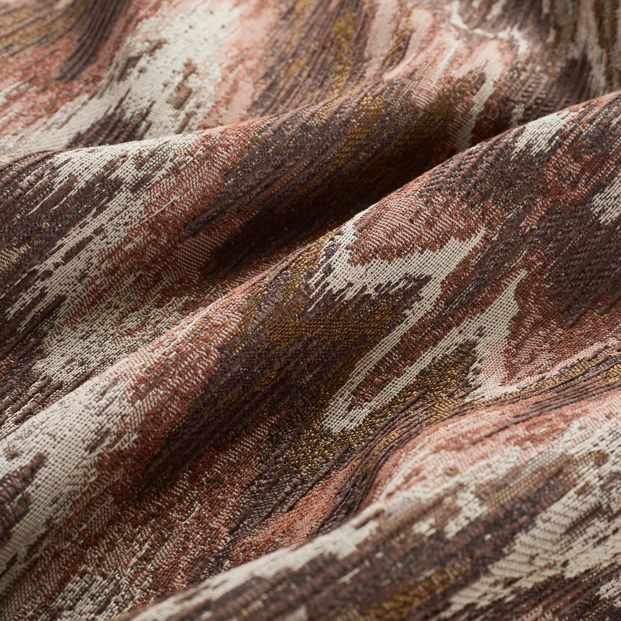 Close up of Tonic Living Mendoza Fig upholstery fabric showing its warm, earthy multicolour pattern.