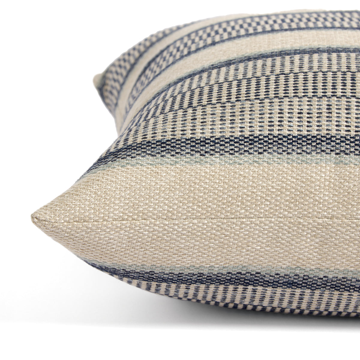 Side view of Tonic Living Miller Stripe Denim decorative pillow highlighting its layered blue and beige banded stripe pattern.