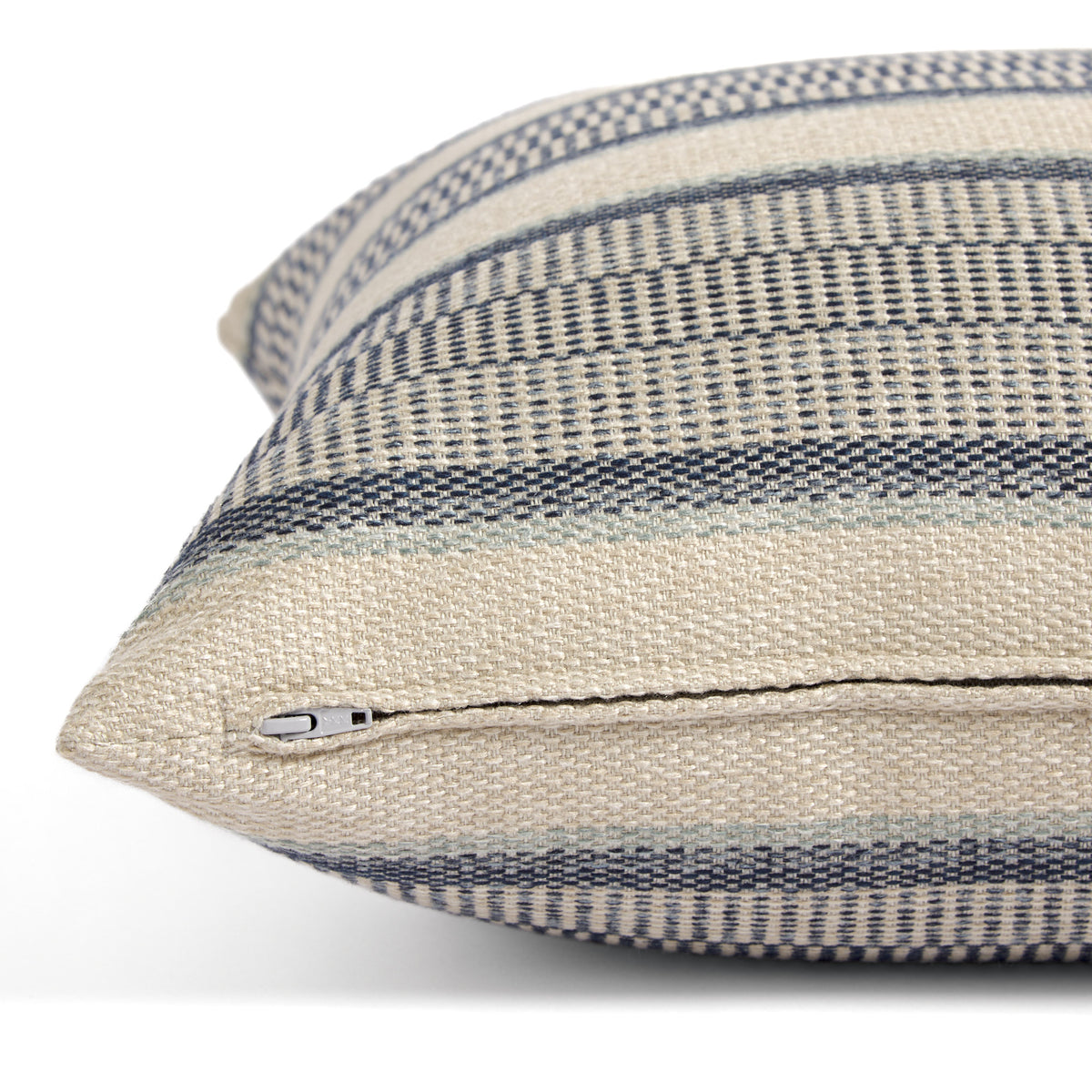 Side zipper detail of Tonic Living Miller Stripe 22x22 toss cushion in dark blue, light blue, and beige stripes.