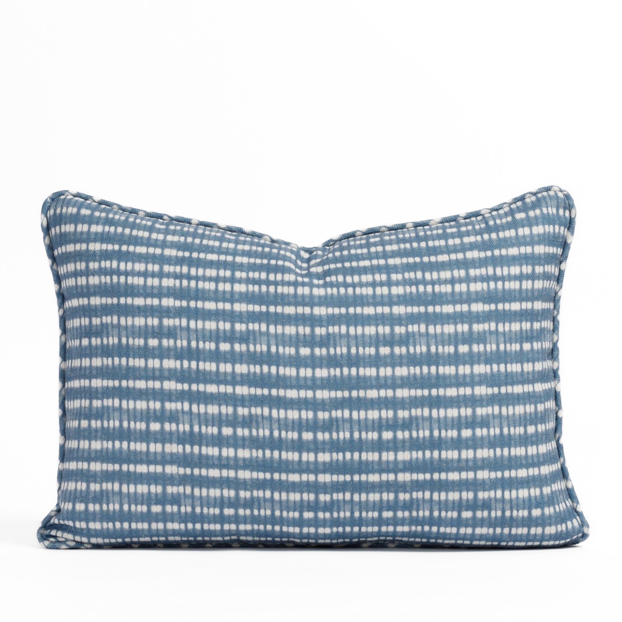 Nile Indigo Lumbar Pillow featuring a blue and white dotted tie-dye style pattern from Tonic Living.