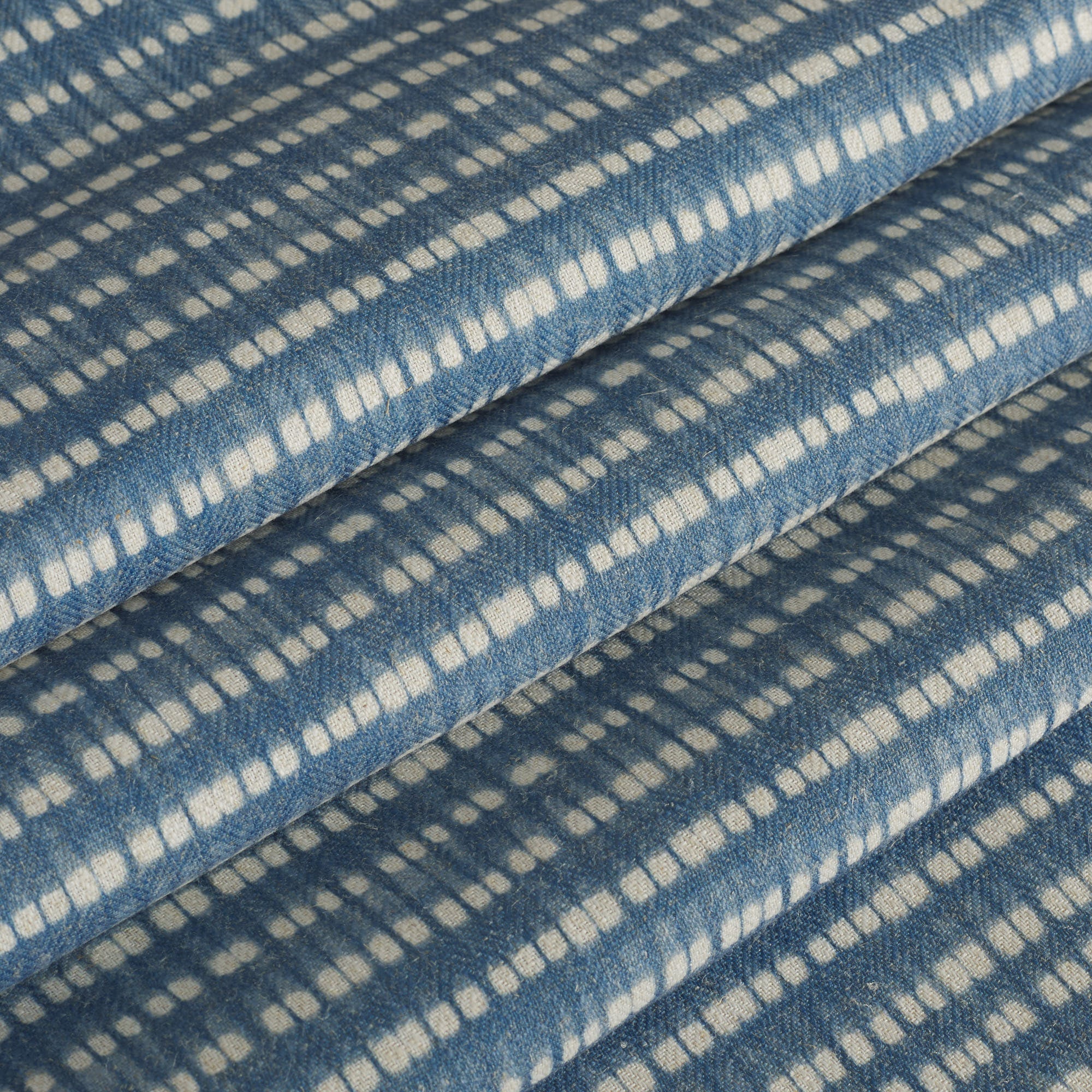 Tonic Living Nile Indigo fabric ideal for roman shades and drapery in a blue and white dotted stripe.