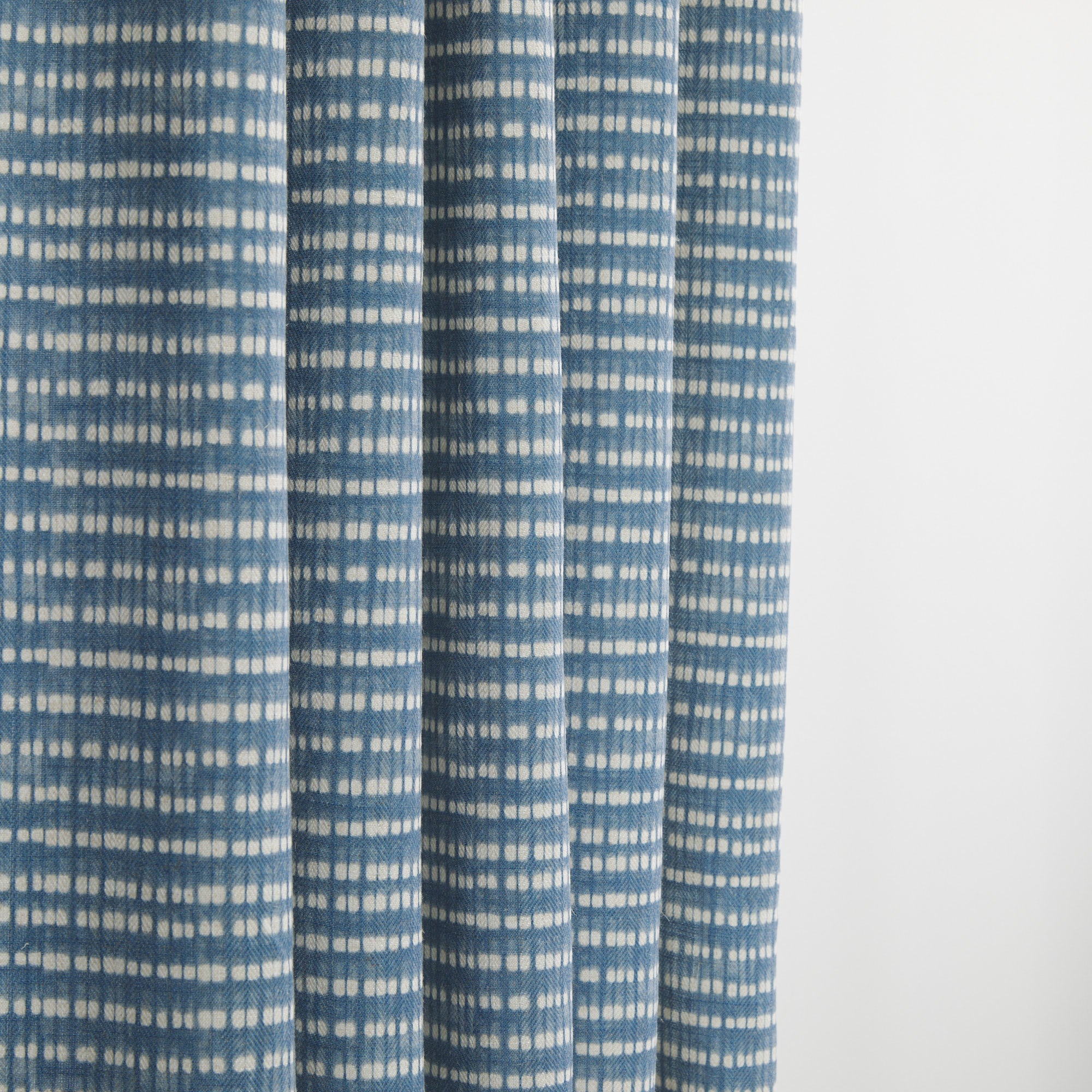 Tonic Living Nile Indigo drapery fabric in a casual blue and white tie-dye inspired stripe.
