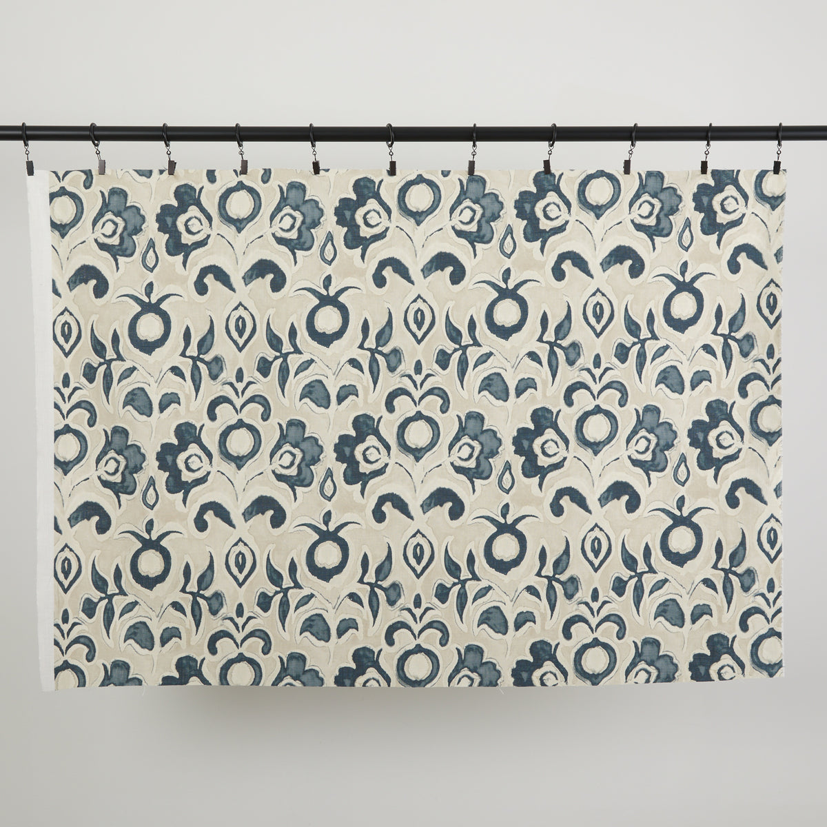 Full yard of Tonic Living Paloma Fabric in Ink hanging to show the scale and drape of its navy blue floral pattern.