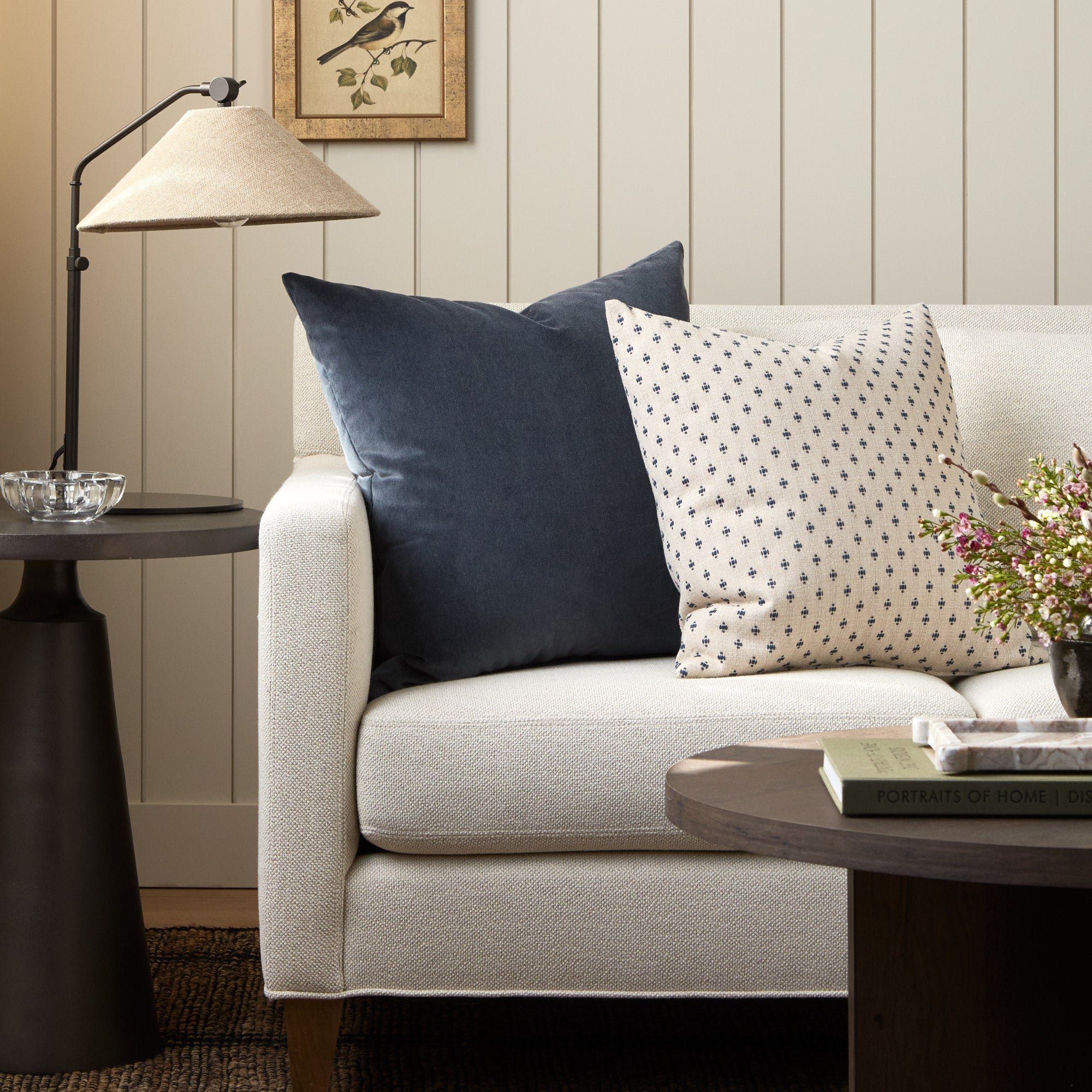 Tonic Living Florence Velvet Mineral Blue throw pillow styled on a sofa with the Pierce Navy 20x20 cushion.