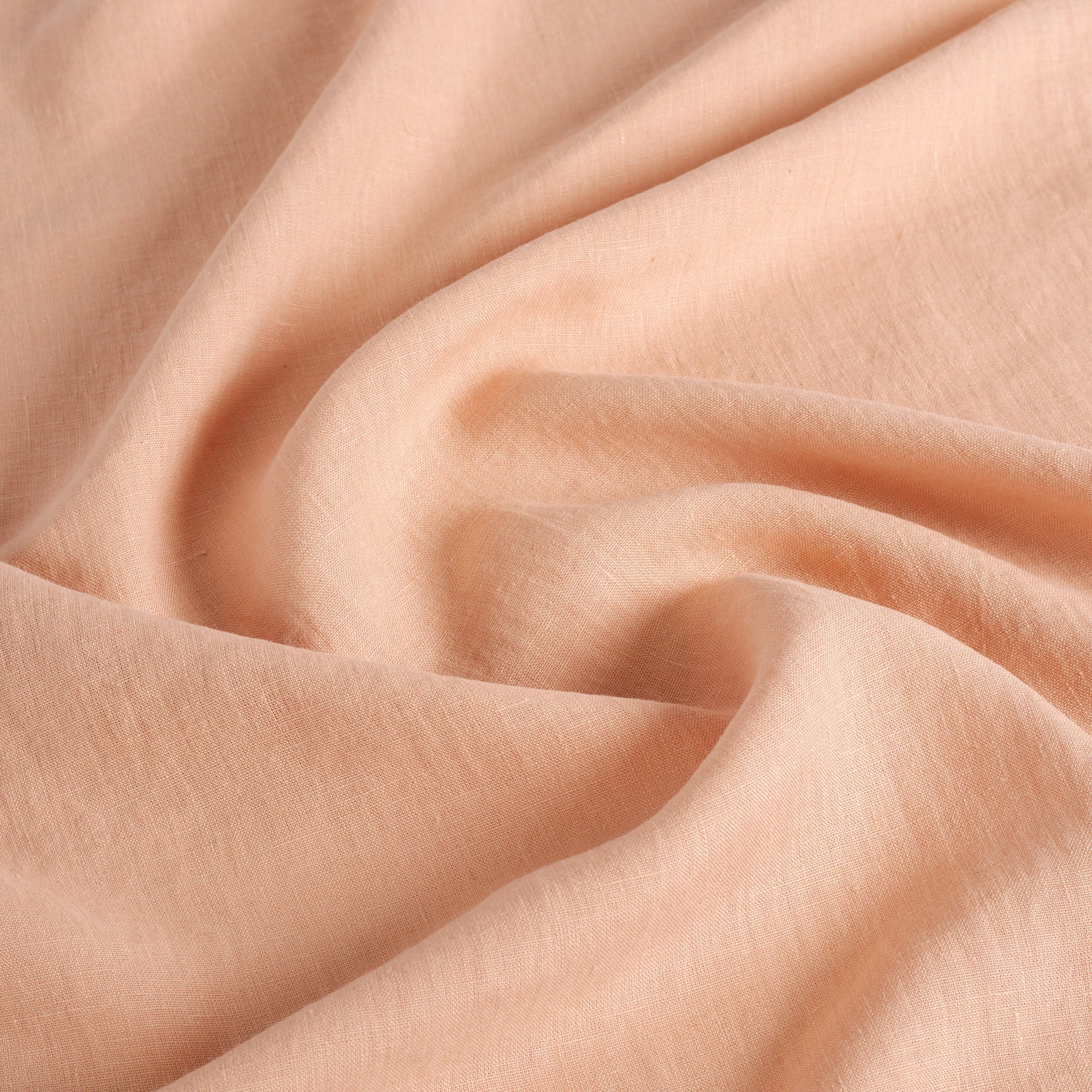 Tonic Living Pietra Salmon Pink 100% linen drapery fabric featuring a soft woven texture and relaxed look.