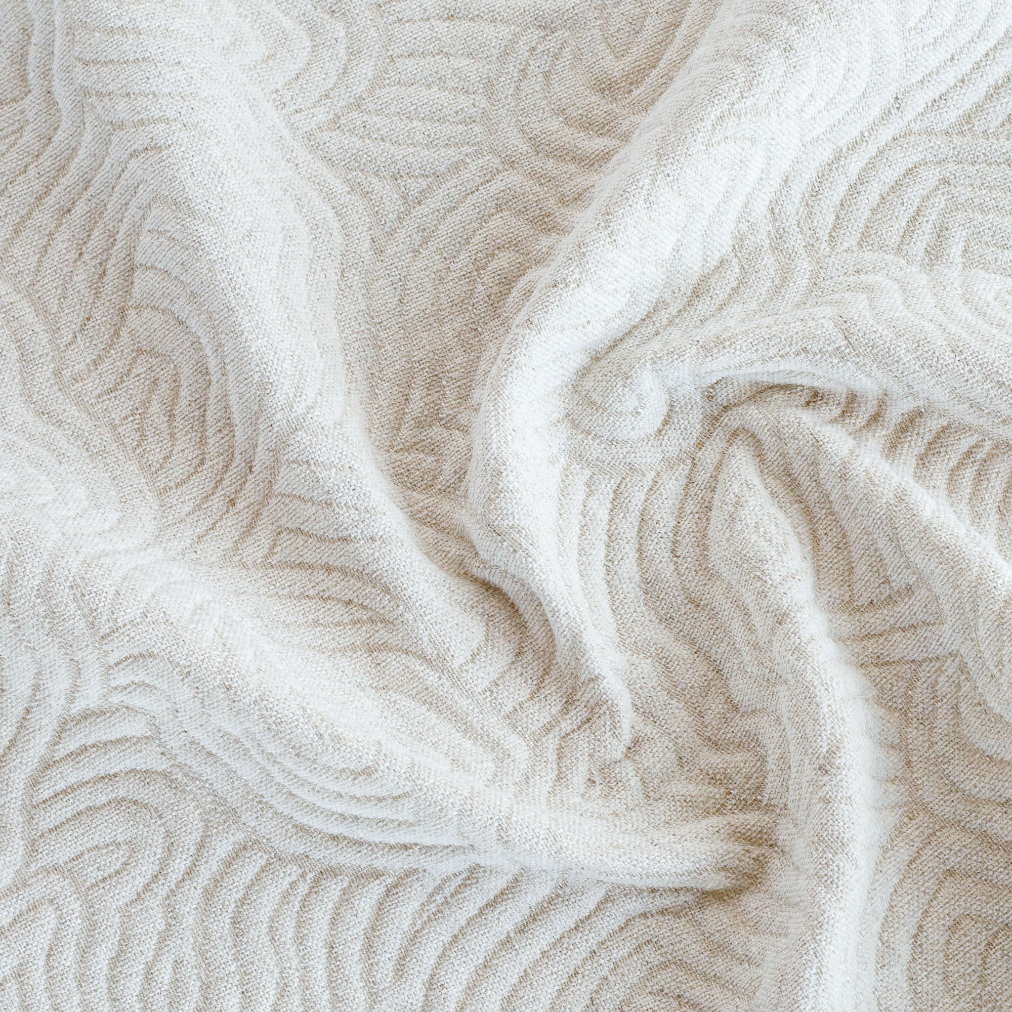 a soft cream and beige quilted abstract wave patterned home decor fabric 