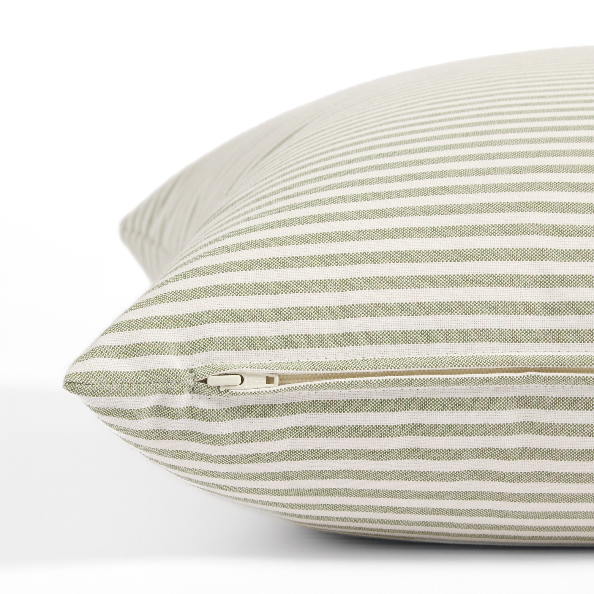 Side zipper detail of Tonic Living Refresh 20x20 outdoor toss pillow in green and white stripe.