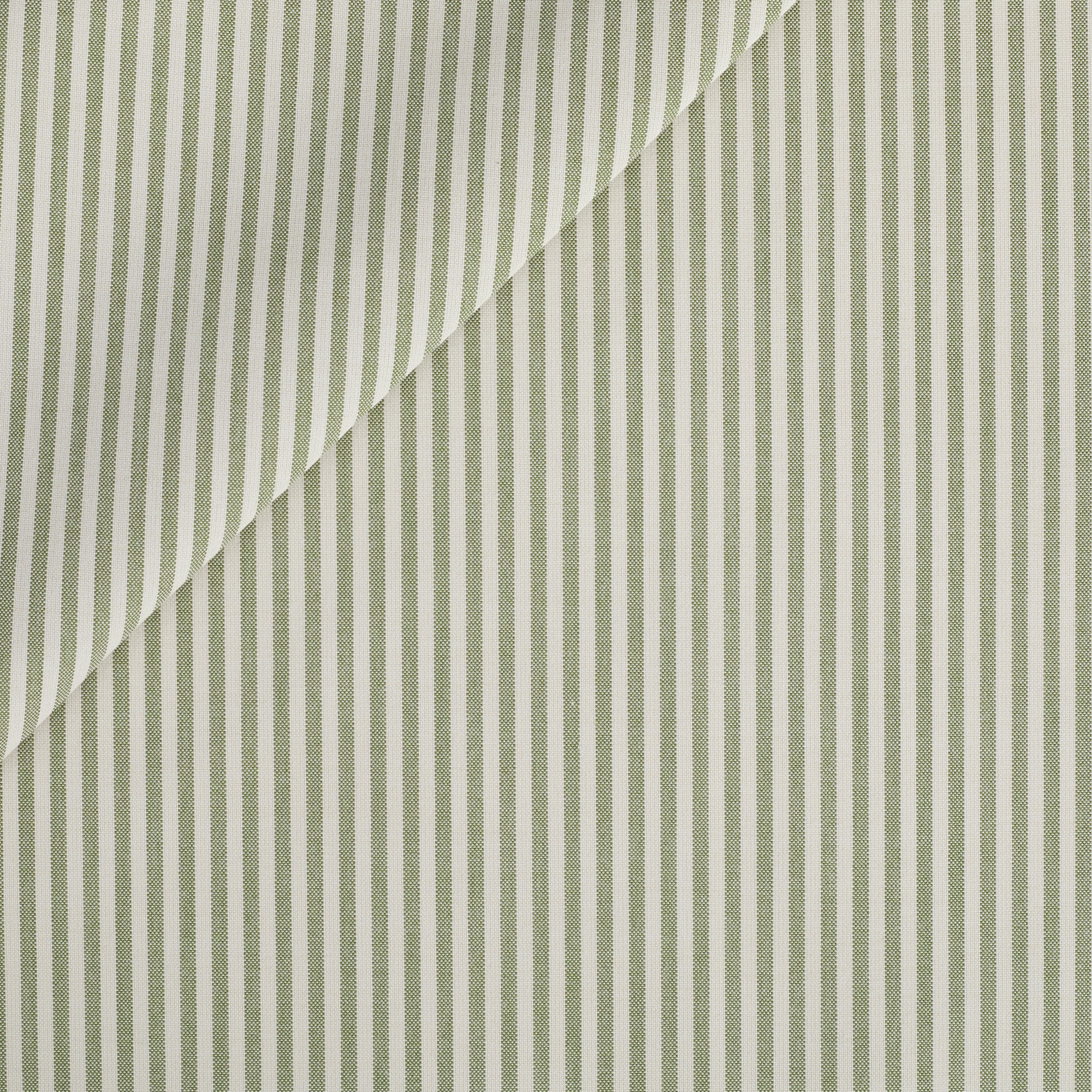 This green and white striped outdoor upholstery fabric features a timeless, narrow stripe with a clean, tailored look. Its classic ticking stripe