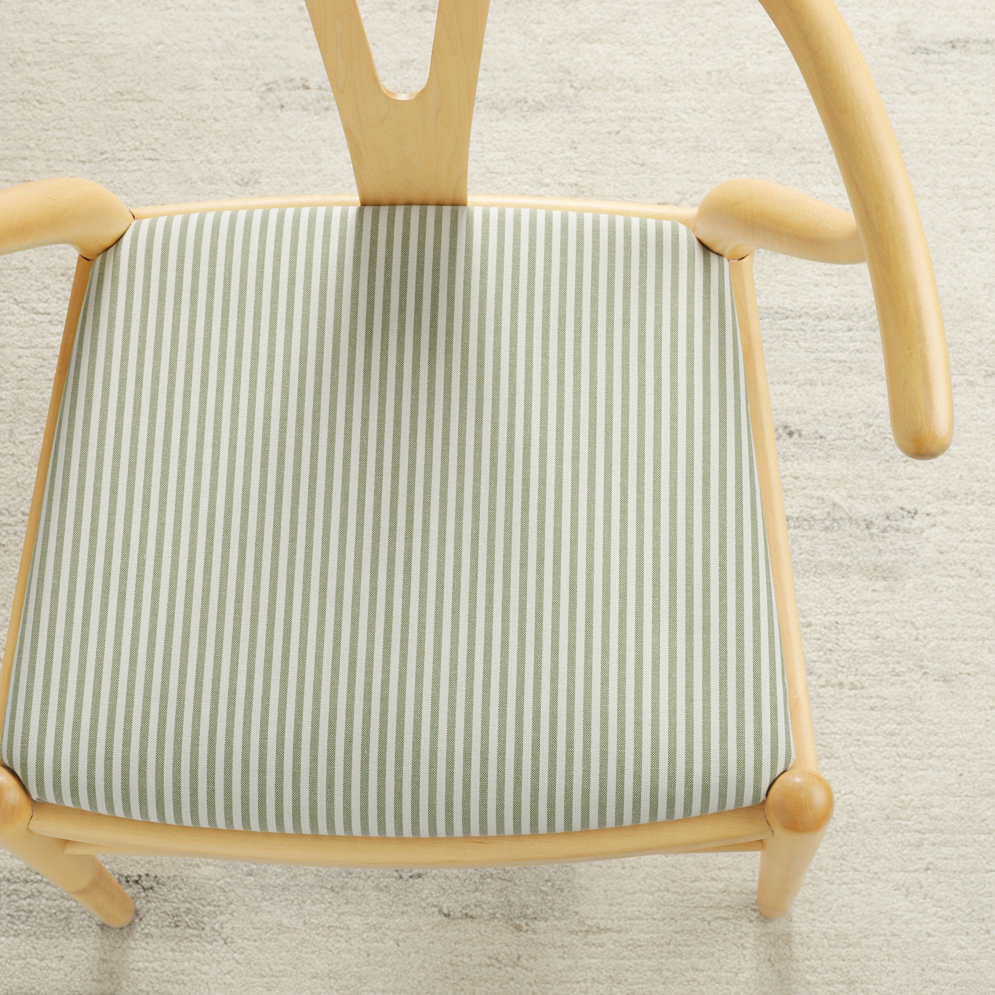 Tonic Living Refresh Sunbrella Hedge outdoor upholstery fabric on a dining chair seat in green and white stripe.