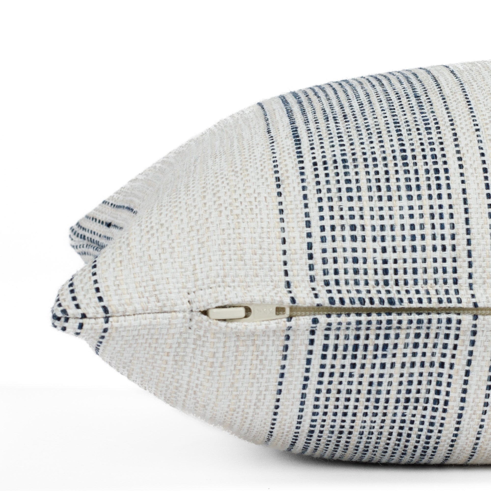 Revitalize Denim Blue lumbar pillow, a striped indoor/outdoor pillow from Tonic Living: close up zipper view.