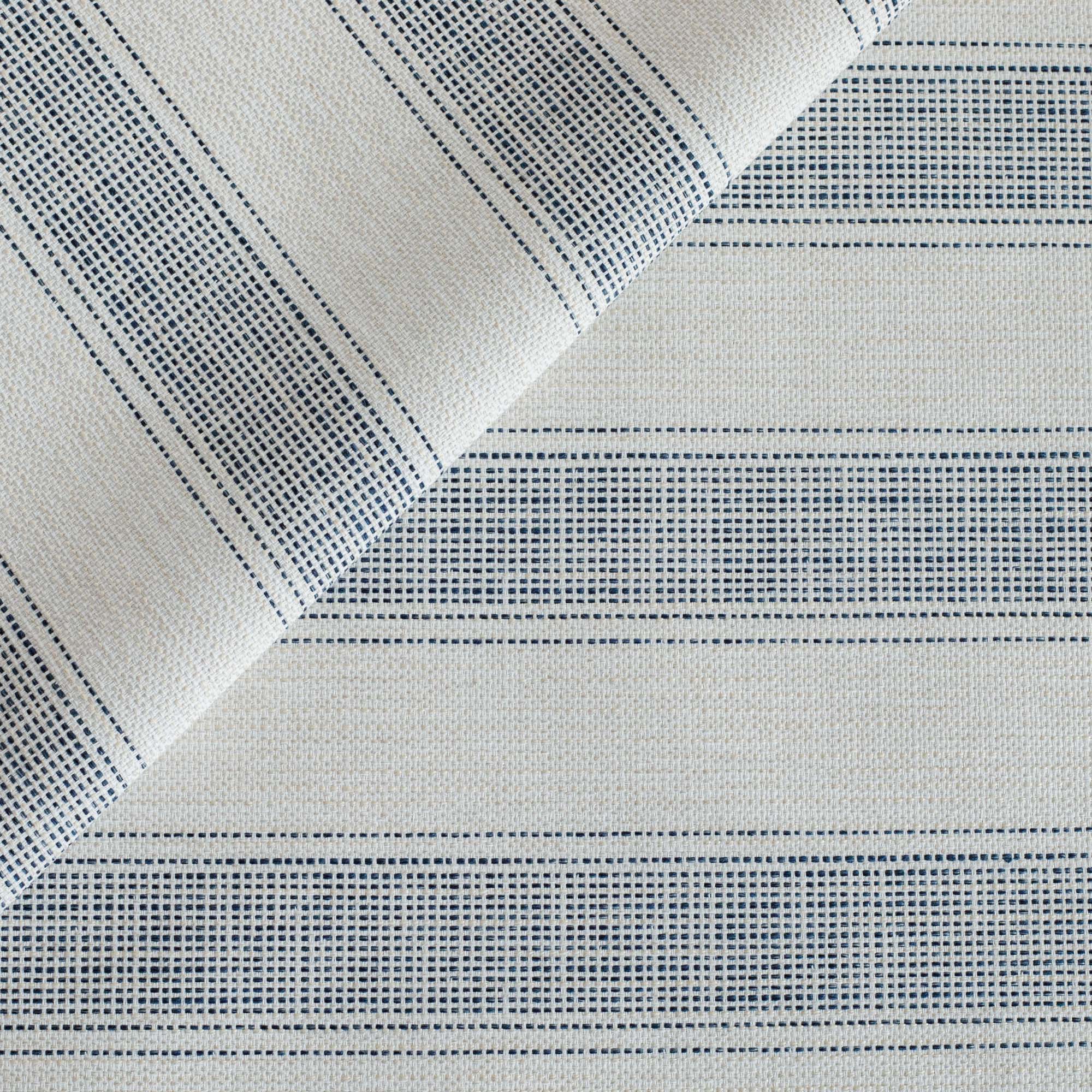 A beige, oatmeal and navy blue stripe indoor/outdoor upholstery fabric from Tonic Living.