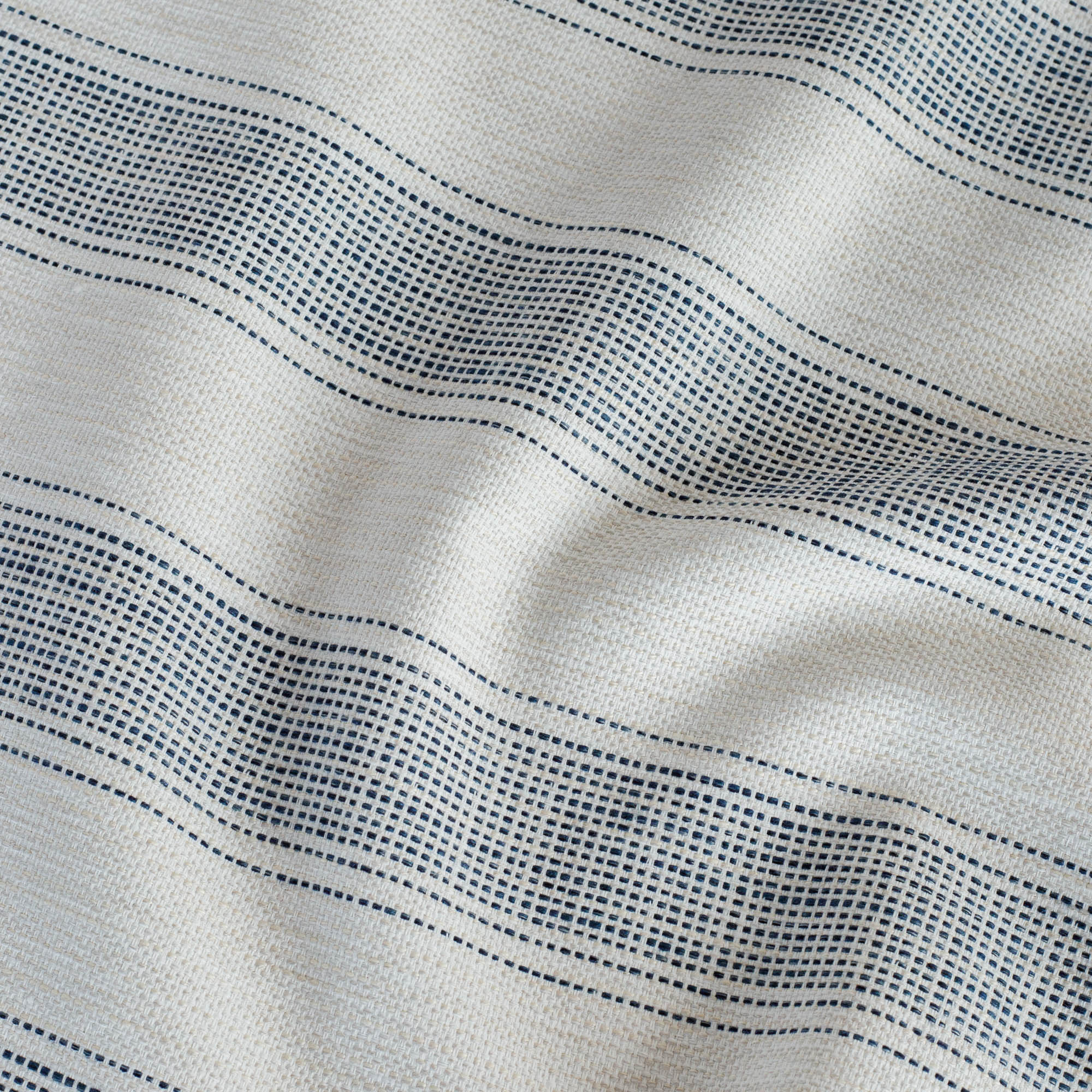 Revitalize Denim Sunbrella Outdoor fabric from Tonic Living - a beige and blue upholstery fabric with running stitch stripes.