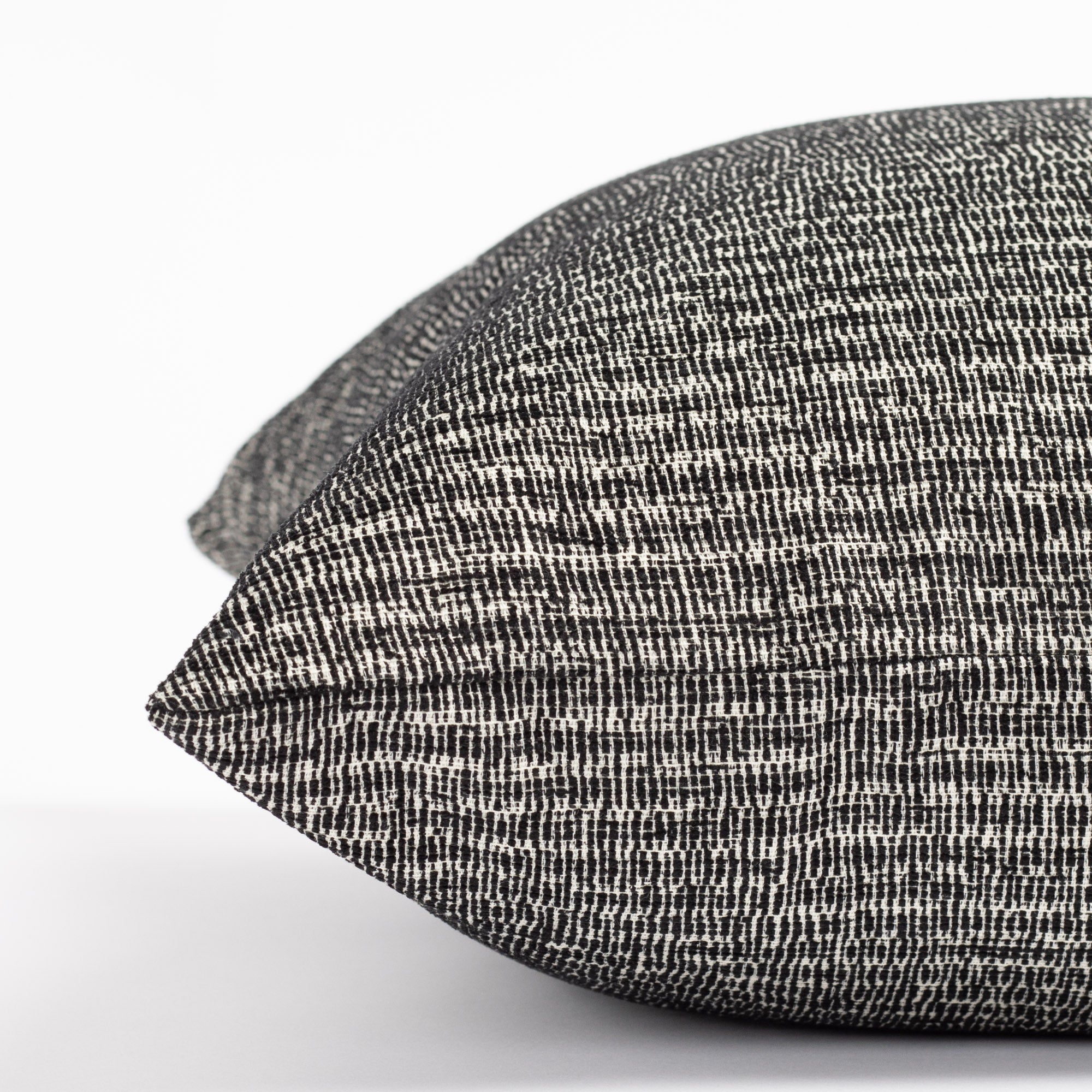 a black and white chenille textured micro patterned pillow : close up side view