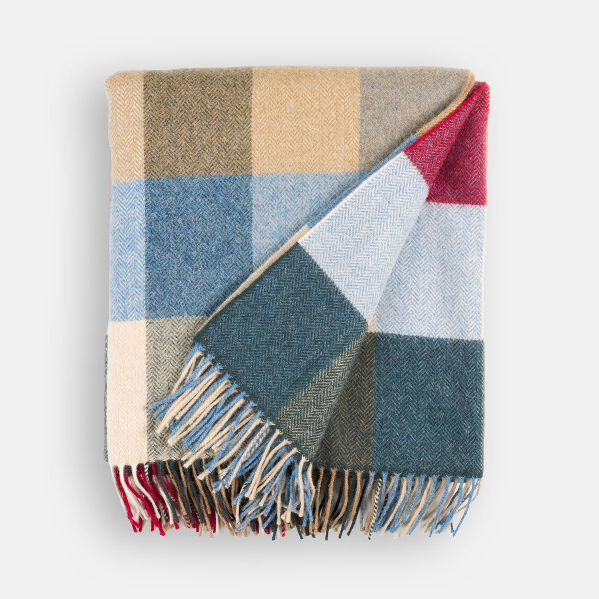 Folded Tonic Living Rowan Check Wool Throw Blanket in Orchard featuring a classic oversized check in blue, red, green, and warm neutrals.