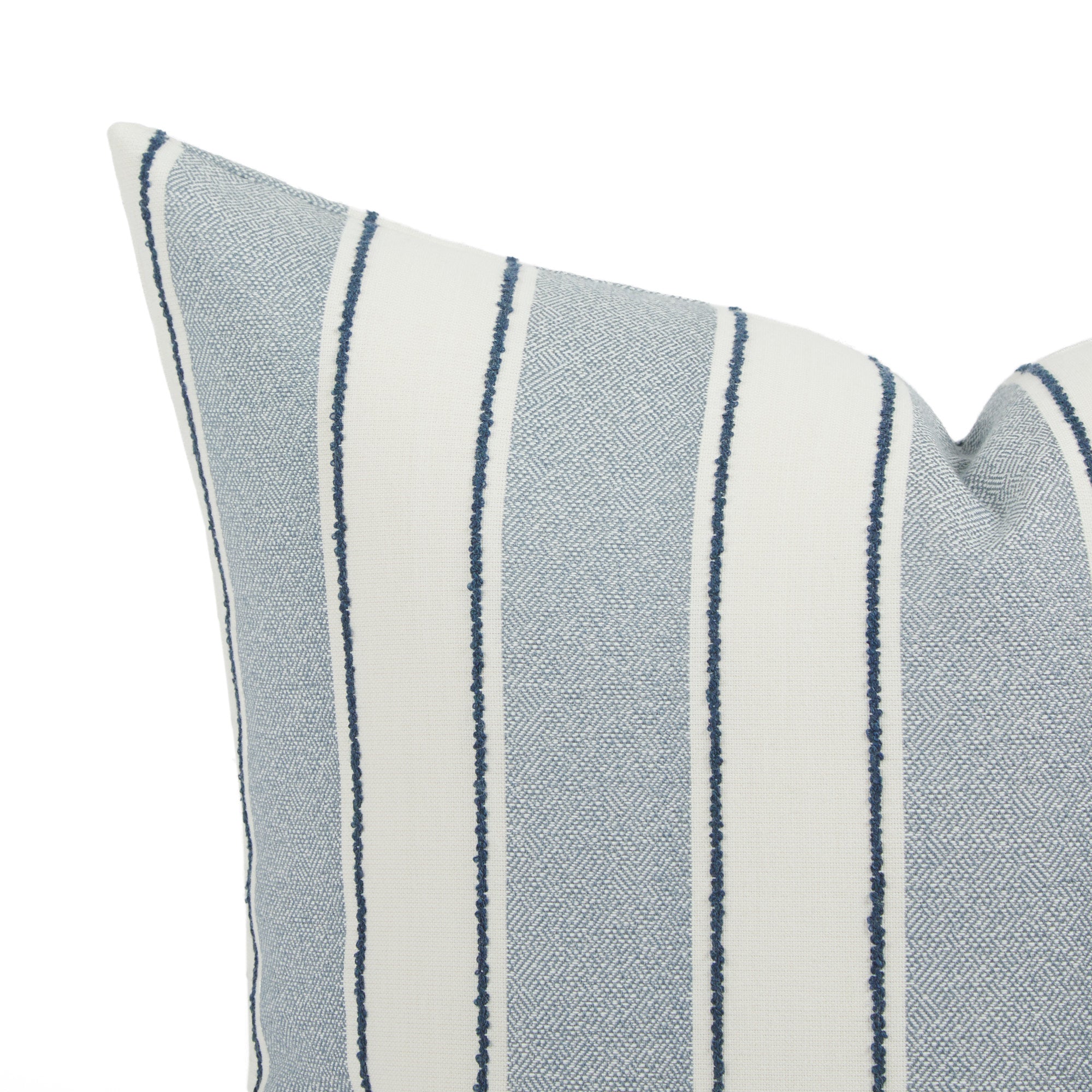 Close up of Tonic Living Sentiment outdoor pillow showing blue and white stripe detail with navy accents.