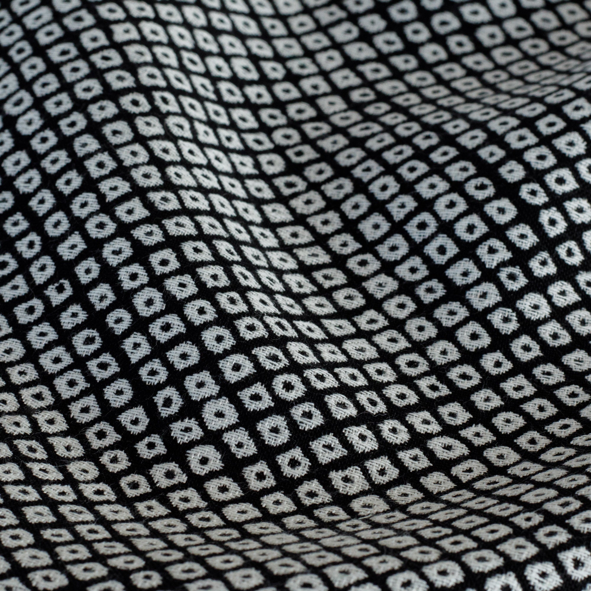 Black and off-white indoor/outdoor upholstery fabric featuring a Japanese-inspired block print pattern from Tonic Living: close up view.