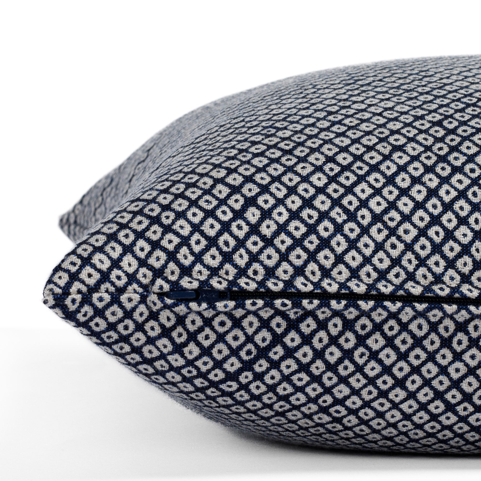 Shibori Indigo, a navy and white Japanese-inspired pattern featuring tightly arranged, organic dots from Tonic Living: close-up zipper view.