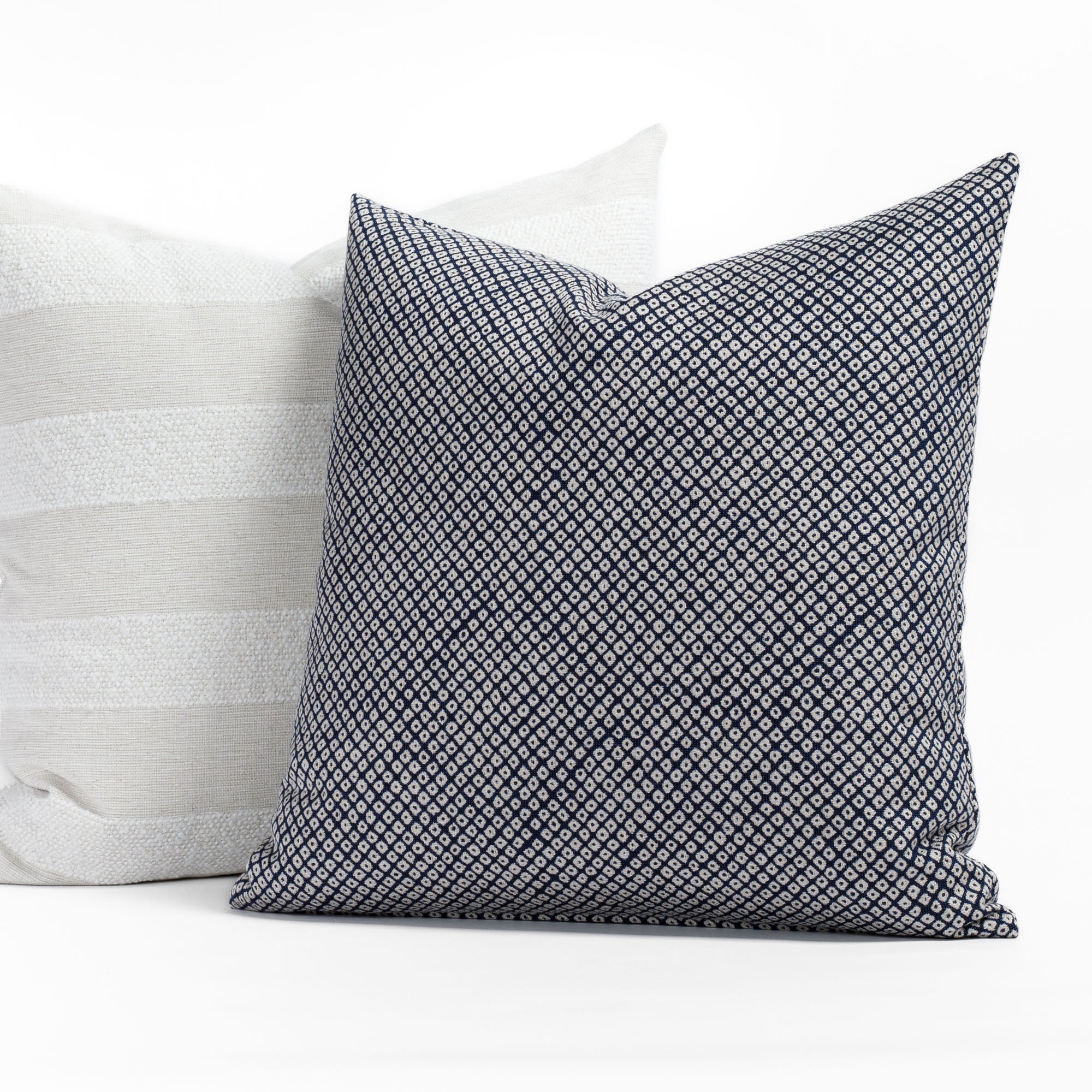 Two navy and neutral toned indoor/outdoor toss pillows from Tonic Living.