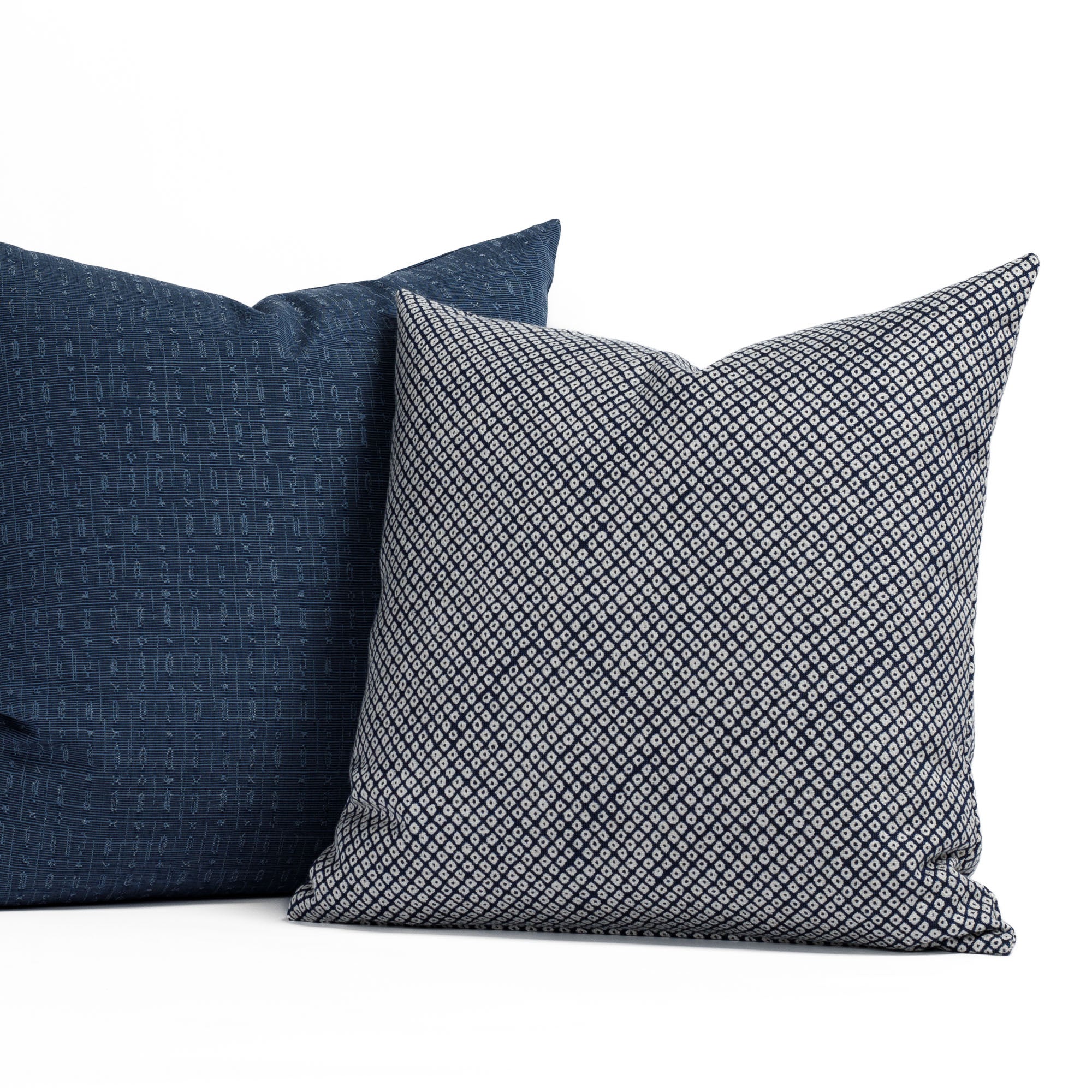 Two navy blue graphic patterned indoor/outdoor toss pillows from Tonic Living.
