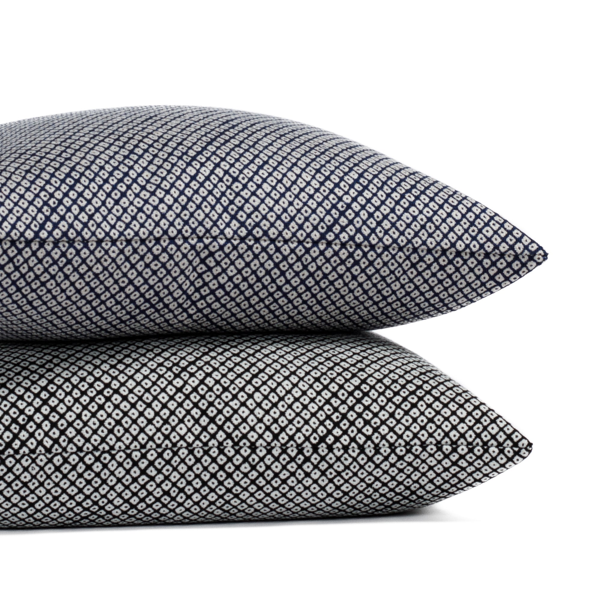 Two Japanese block print style indoor/outdoor pillows from Tonic Living, in black and navy blue.