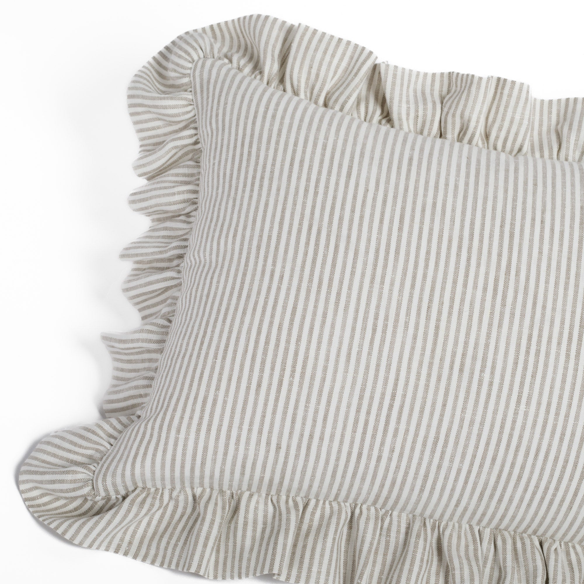 Angled view of the Siena Buff ruffled lumbar cushion by Tonic Living, capturing the cozy, vintage-inspired silhouette and textural linen-blend fabric.