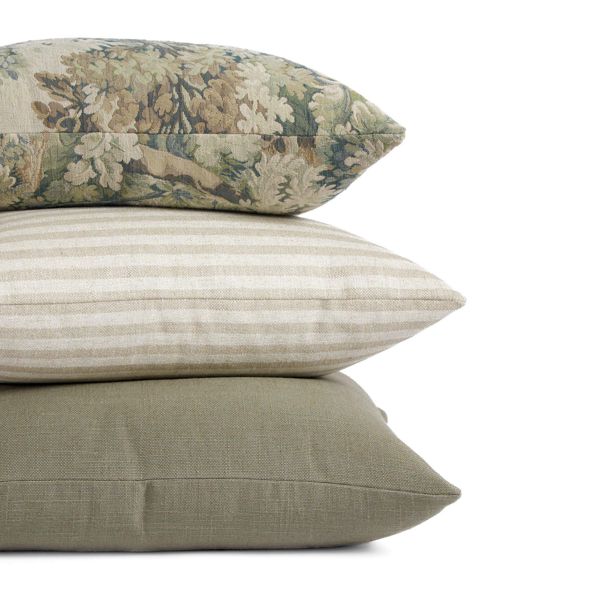 Stack of Tonic Living pillows including Manor Sage, Somerset Stripe Oatmeal, and Hampton Sage.