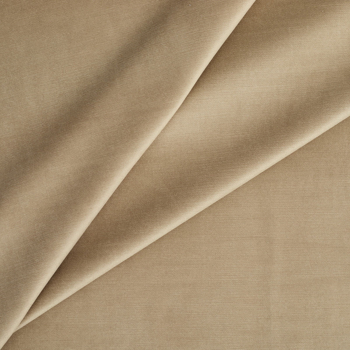 Tonic Living Sterling Velvet Bark upholstery fabric featuring warm light brown and golden tan tones with a refined velvet texture.