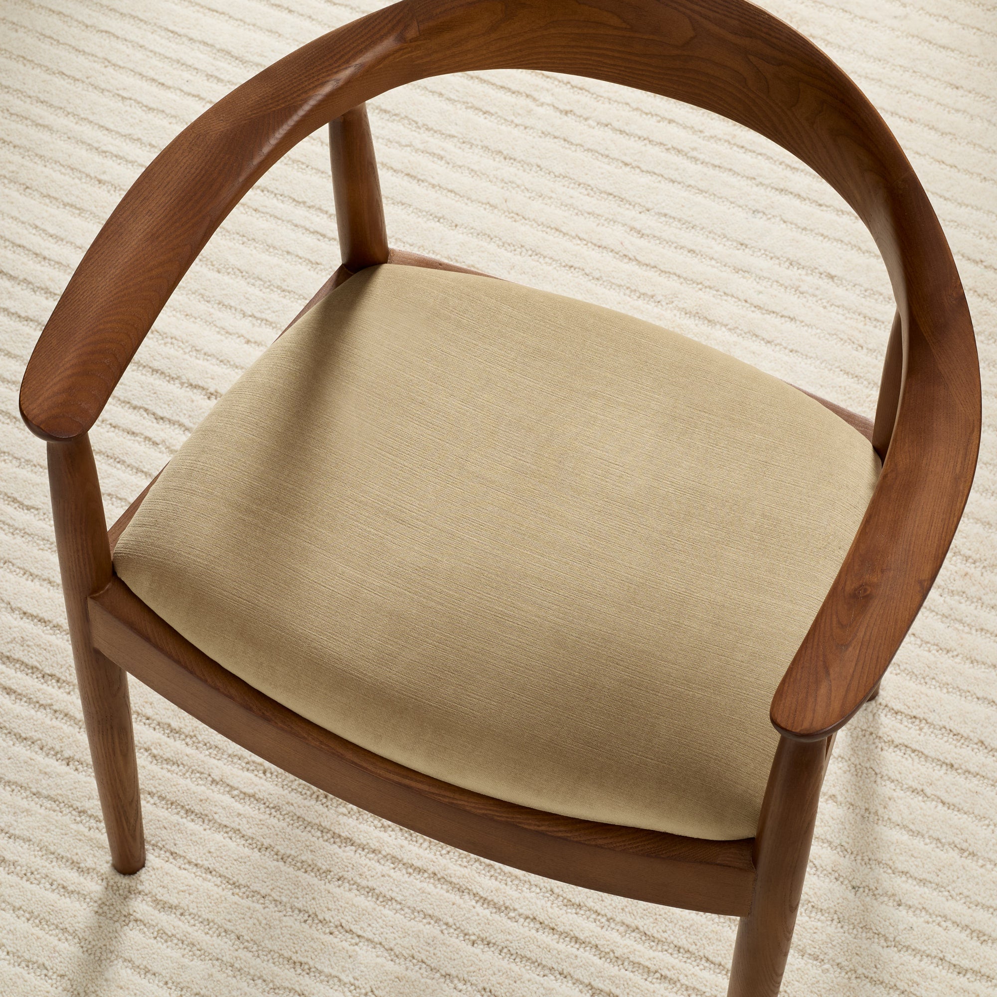 Tonic Living Sterling Velvet Bark brown upholstery fabric shown on a dining chair seat with a luxurious velvet finish.