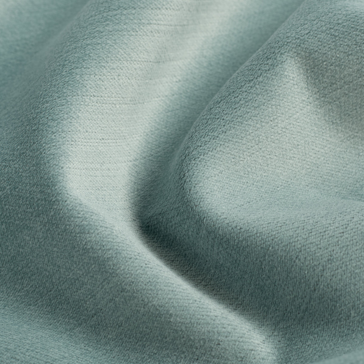 Close up of Tonic Living Sterling Velvet Lake fabric showing aqua blue velvet, fine linear texture, and luminous colour variation.
