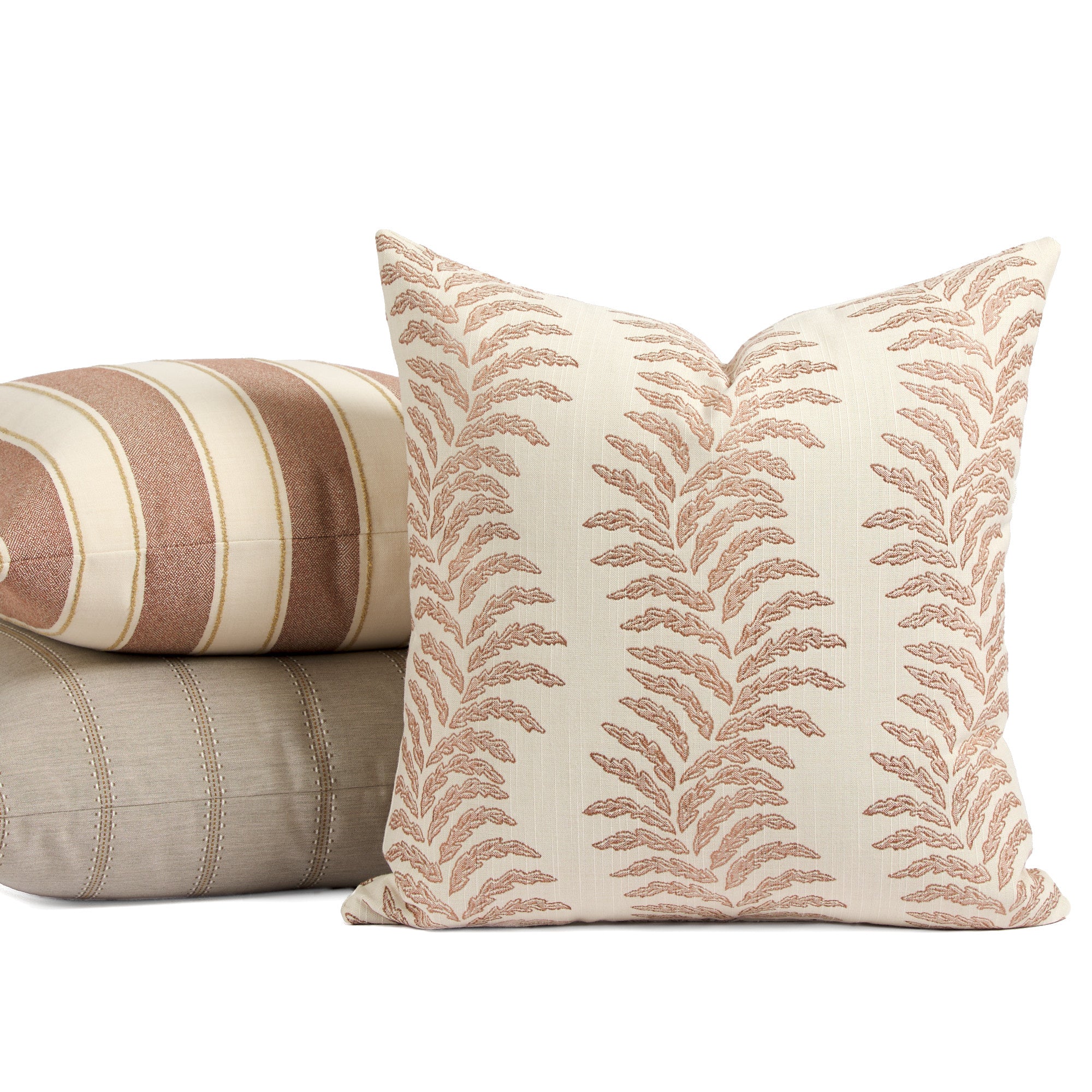 Tonic Living Swoon Terracotta decorative pillow styled in front of cream and terracotta cushions.
