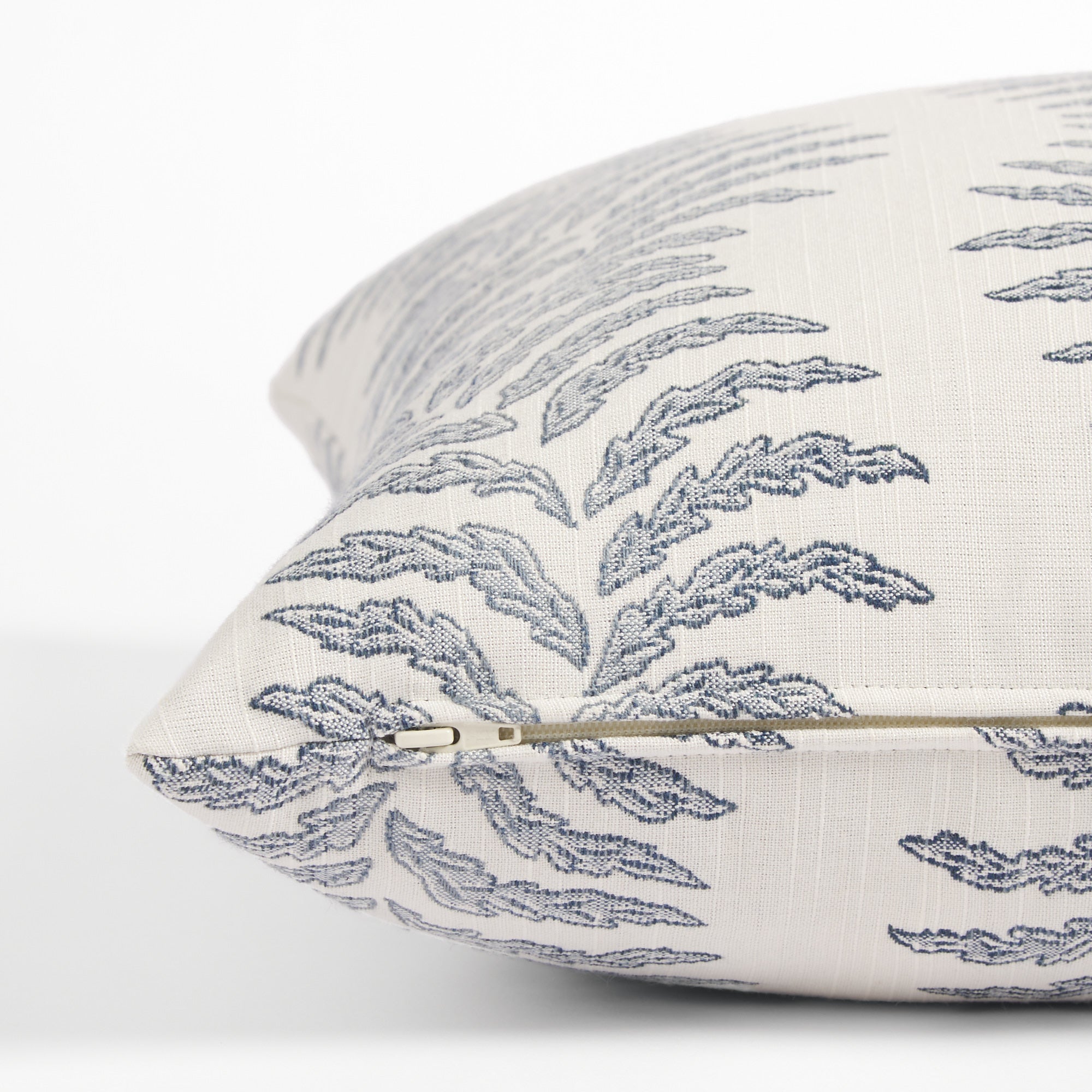 Side zipper detail of Tonic Living Swoon 20x20 outdoor toss pillow in blue and white stripe.