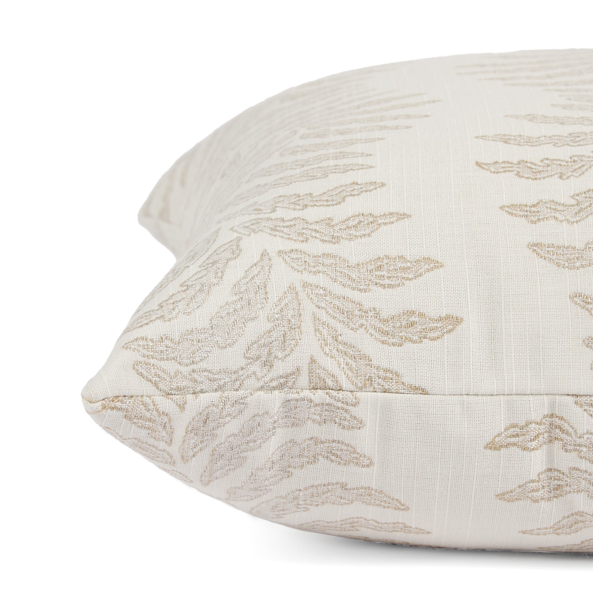 Close up of Tonic Living Swoon Sand cushion highlighting its soft woven texture and botanical stripe.