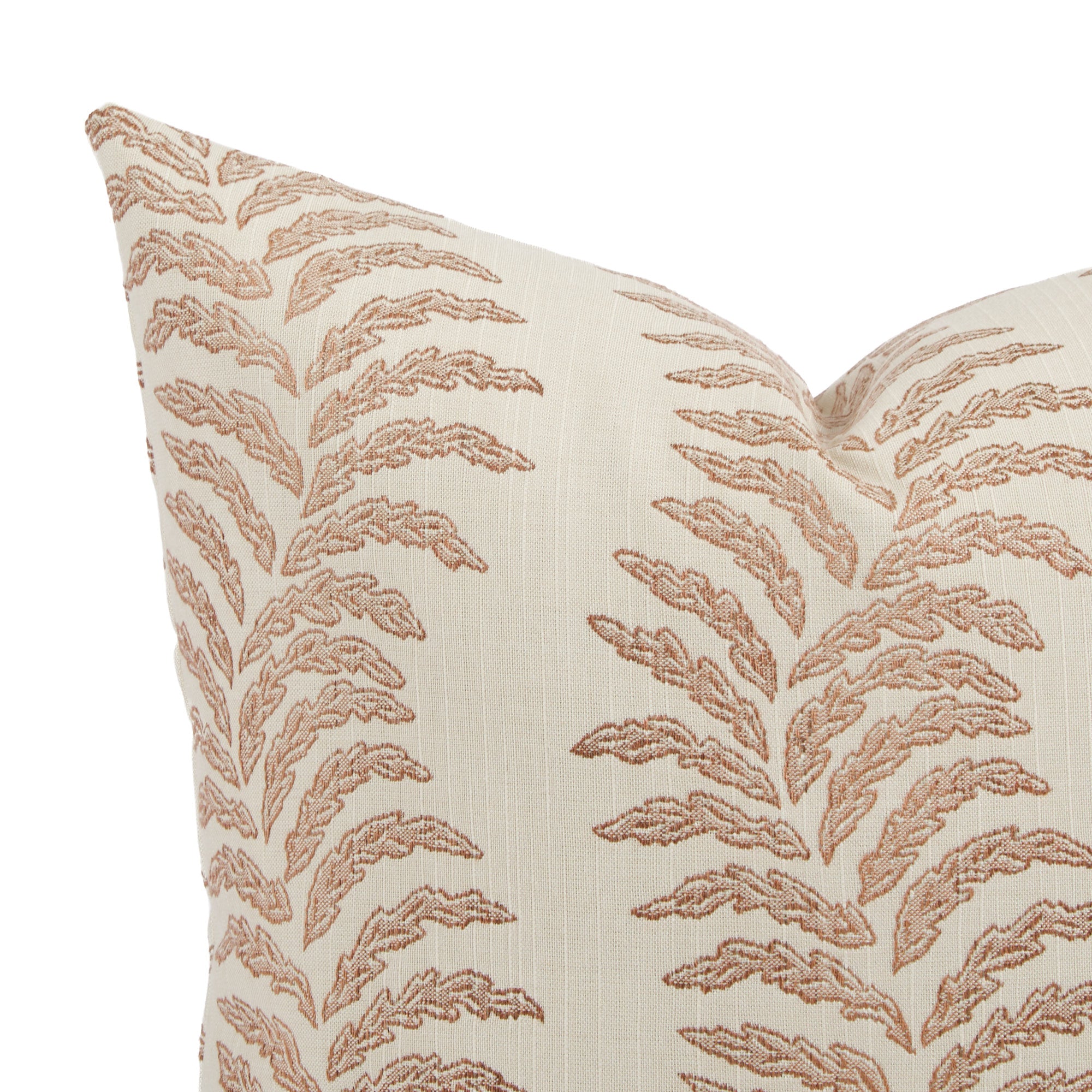 Close up of Tonic Living Swoon outdoor pillow showing terracotta and white botanical stripe detail.