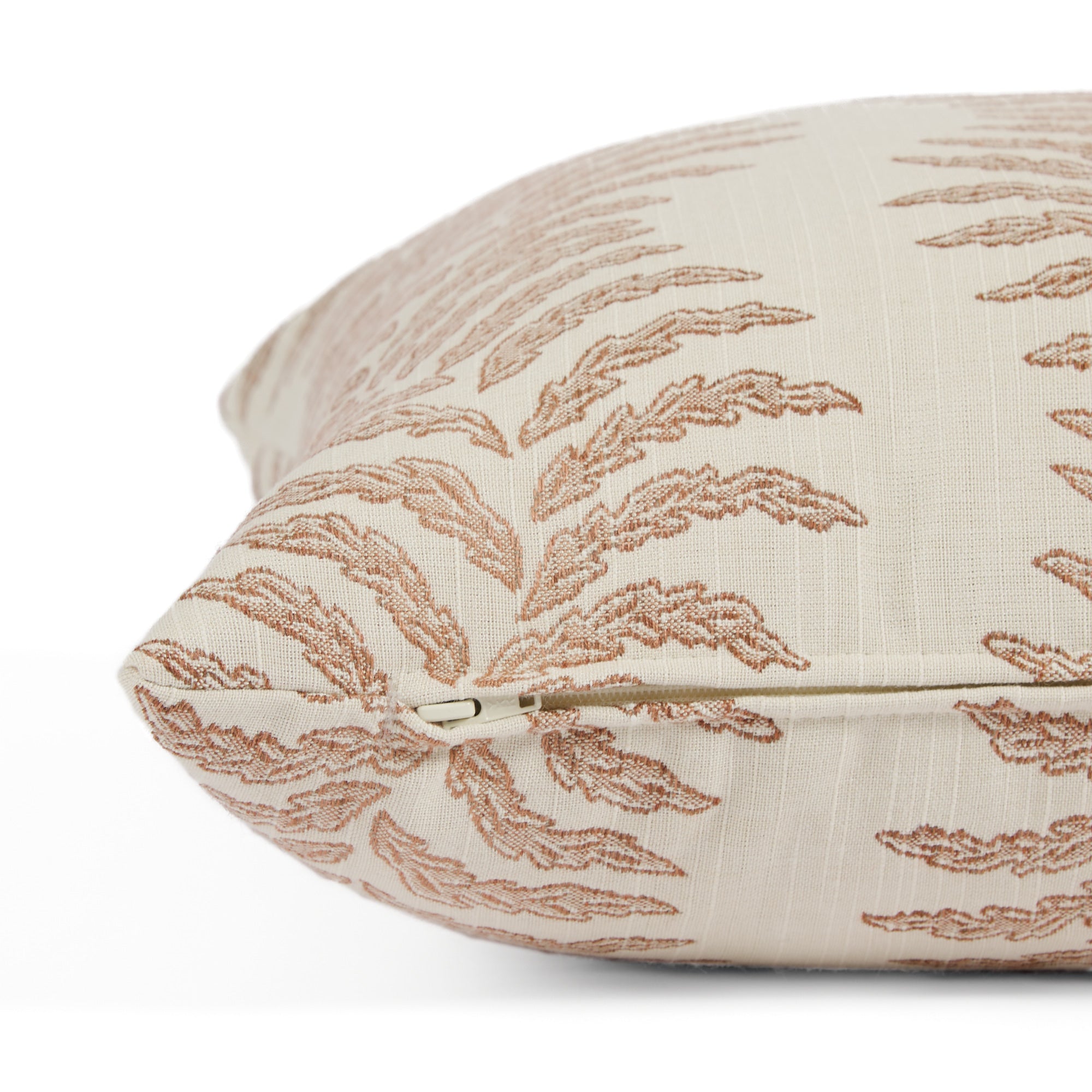 Side zipper detail of Tonic Living Swoon 20x20 outdoor toss pillow in terracotta and white stripe.