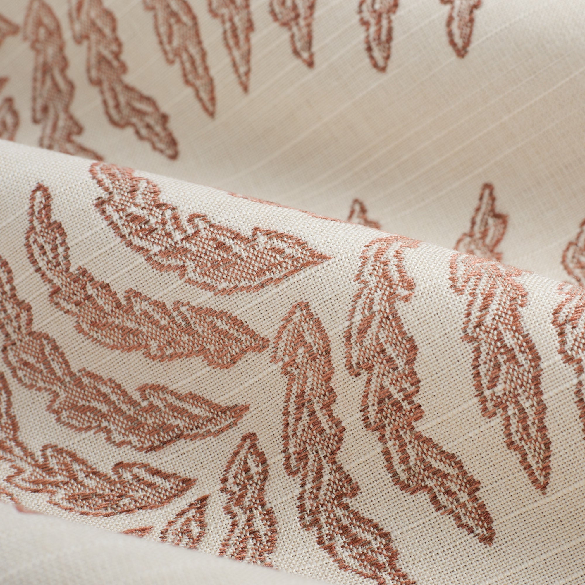 Close up of Tonic Living Swoon Sunbrella Terracotta fabric showing dusty terracotta and white botanical stripe detail.