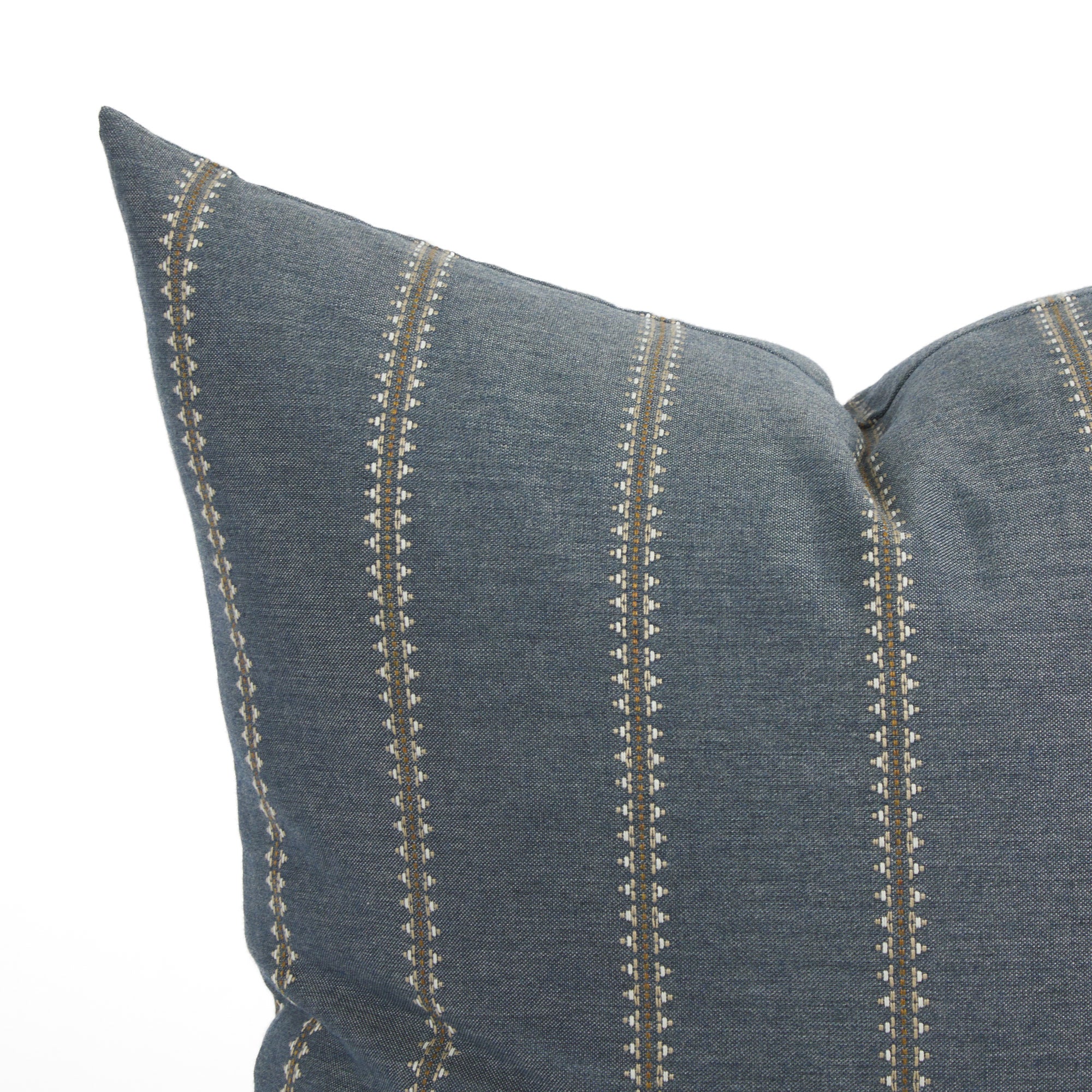 Close up of Tonic Living Talisman outdoor cushion showing denim blue fabric with raised stitch geometric stripe detail.