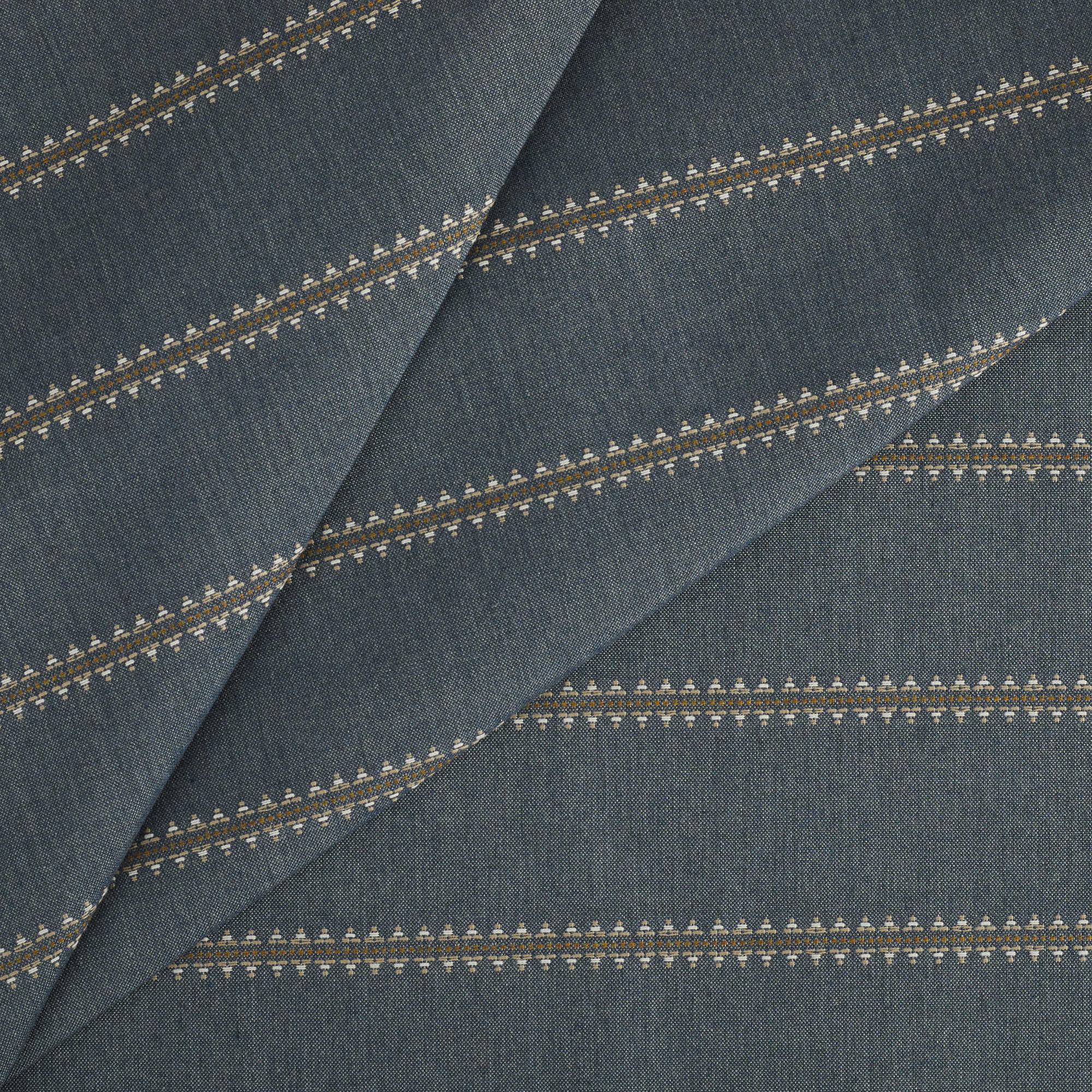 Tonic Living Talisman Sunbrella Denim blue performance fabric featuring a subtle embroidered stripe with geometric interest.