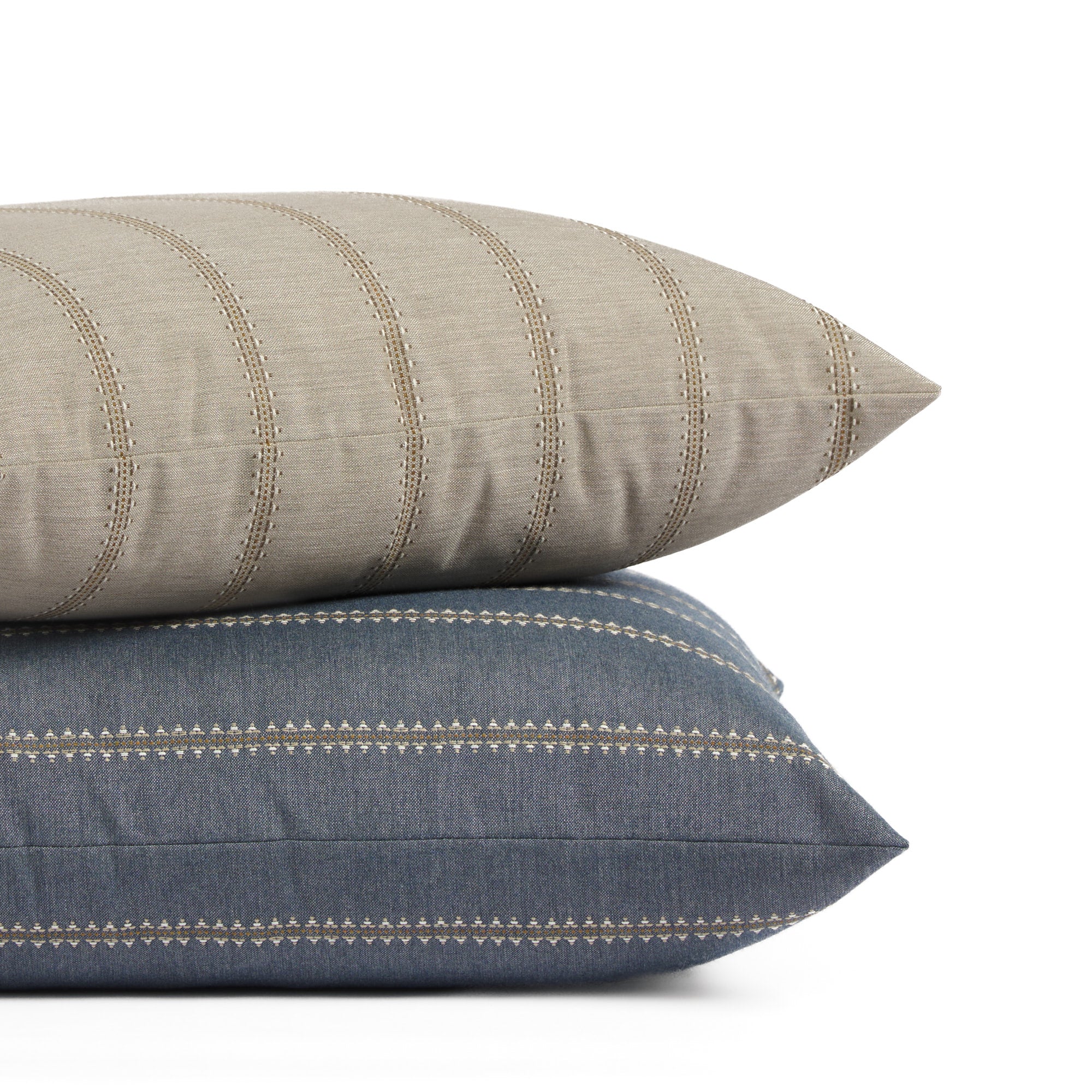 Tonic Living Talisman pillow collection in Sand and Denim Blue featuring embroidered stripe designs in neutral and blue tones.