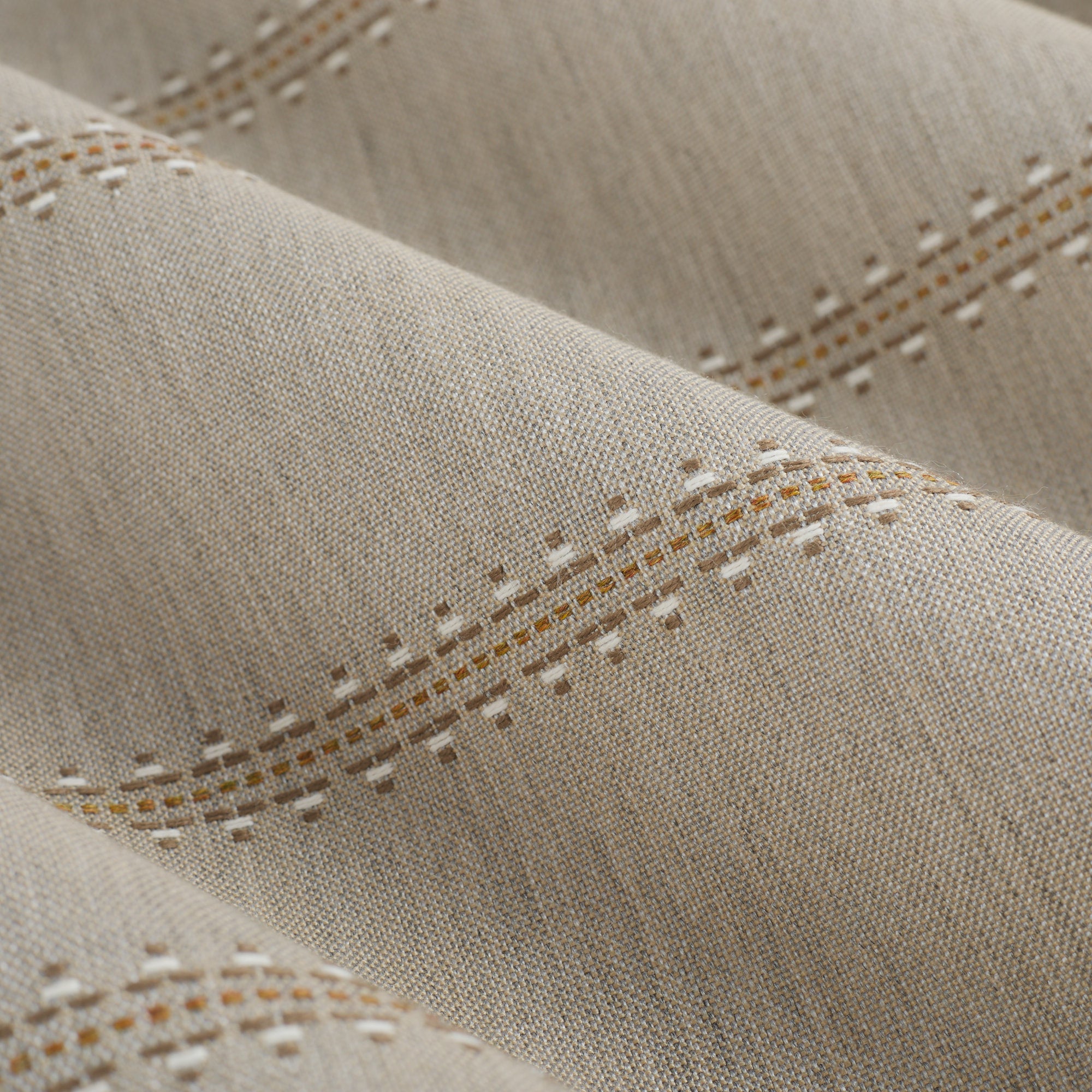 Close up of Tonic Living Talisman Sunbrella Sand fabric showing raised stitched stripe detail in sand and taupe.