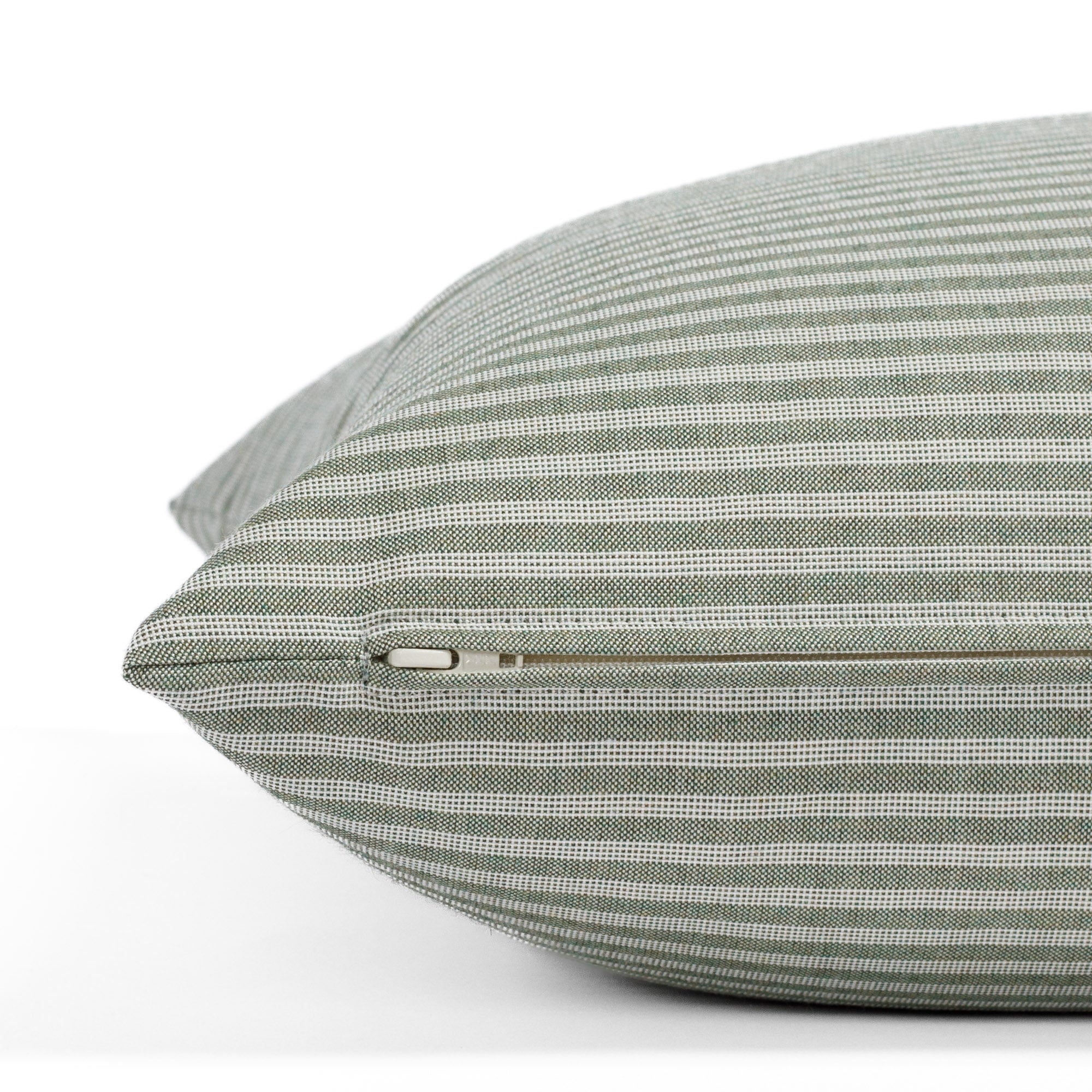 Tap 22x22 Indoor/Outdoor Pillow, a mossy green and white ticking stripe pillow: close-up zipper view.