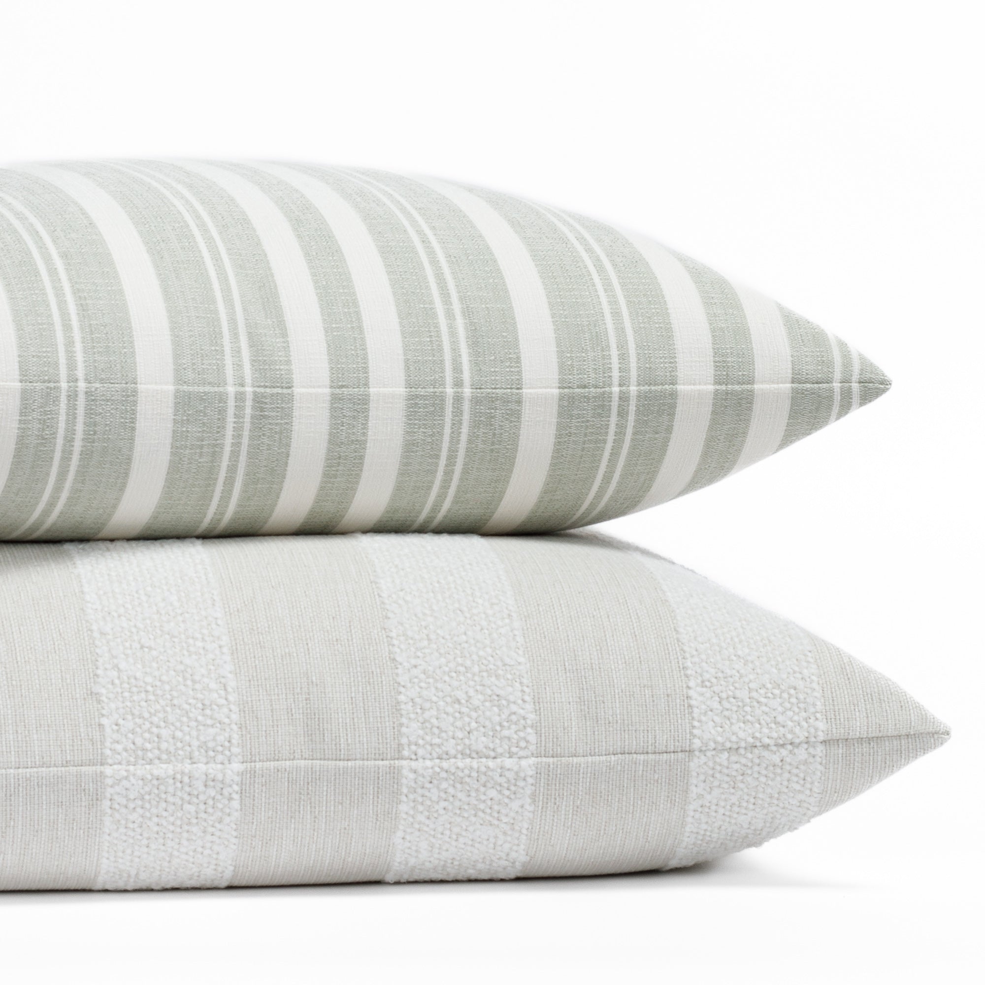 Two soft green and white striped indoor/outdoor pillows from Tonic Living.