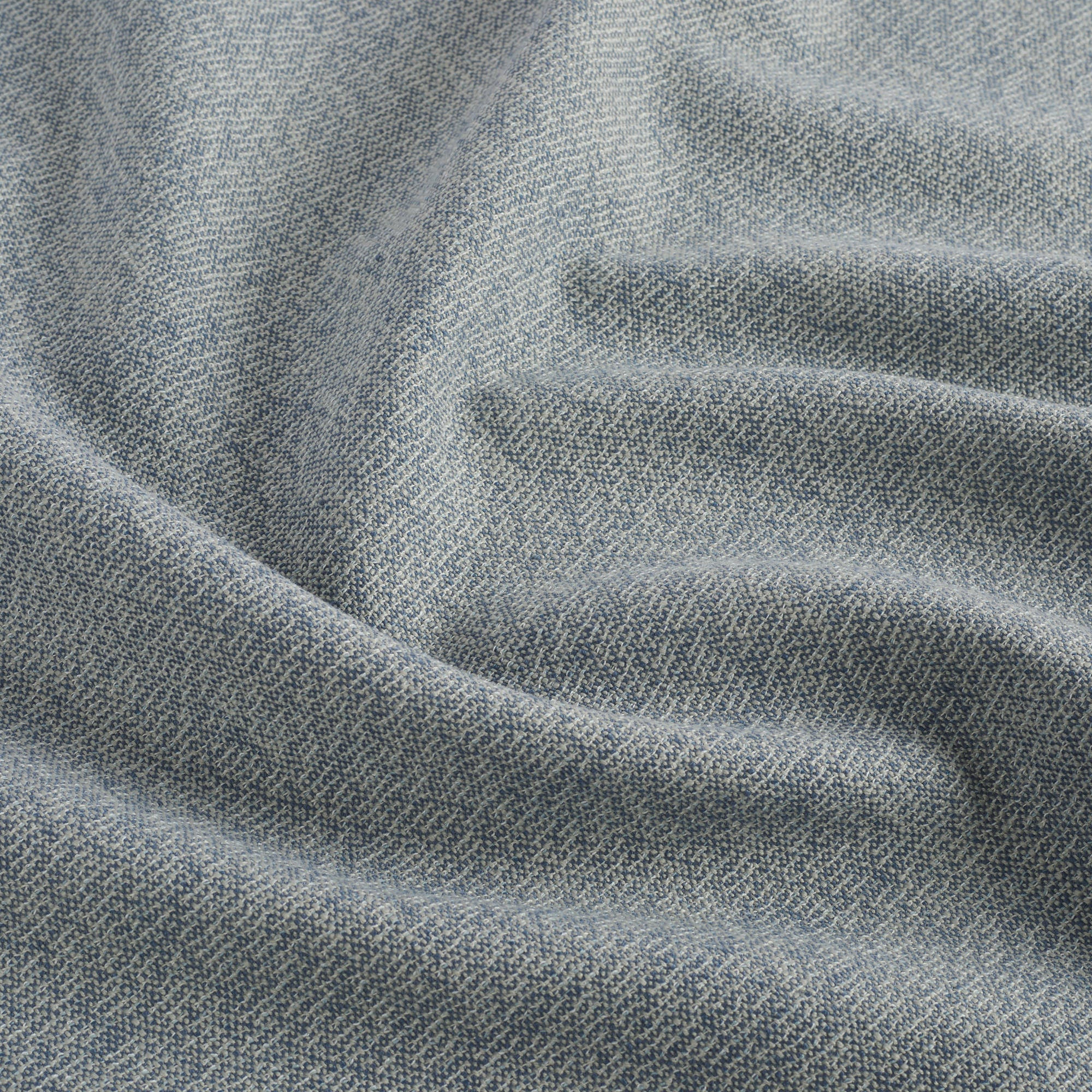 Close up of Tonic Living Troy InsideOut Denim indoor/outdoor fabric showing rich blue linen-like texture.